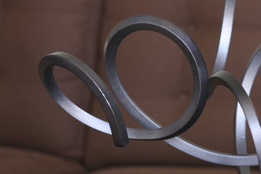 Twisted steel abstract sculpture, black anodized, close up