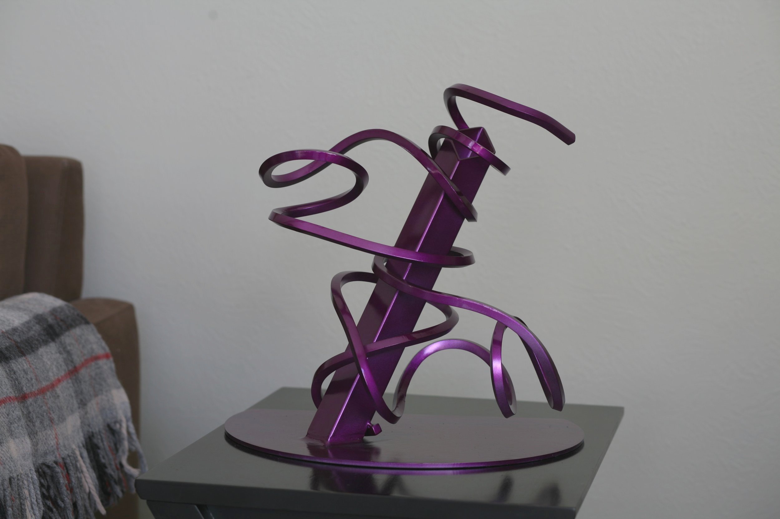 Twisted steel abstract sculpture with square tube, purple metallic