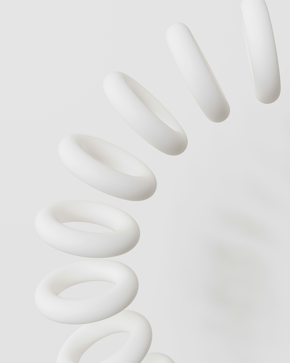 A digital abstract art composition featuring a series of white, donut-shaped rings arranged vertically with varying shadow and lighting effects, set against a light gray background.