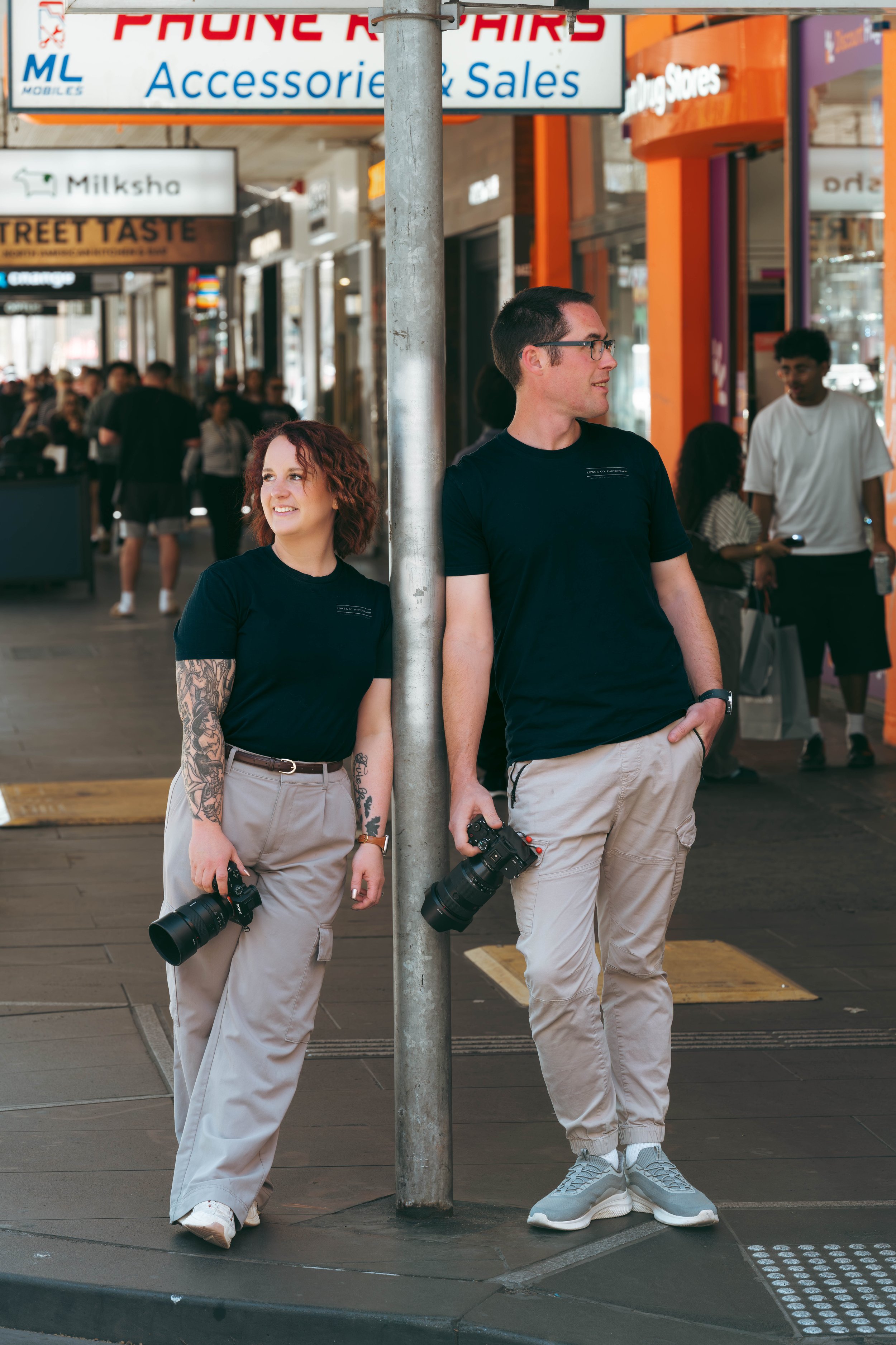 Melbourne Wedding Photographers in the city with cameras in their hands ready to shoot a wedding