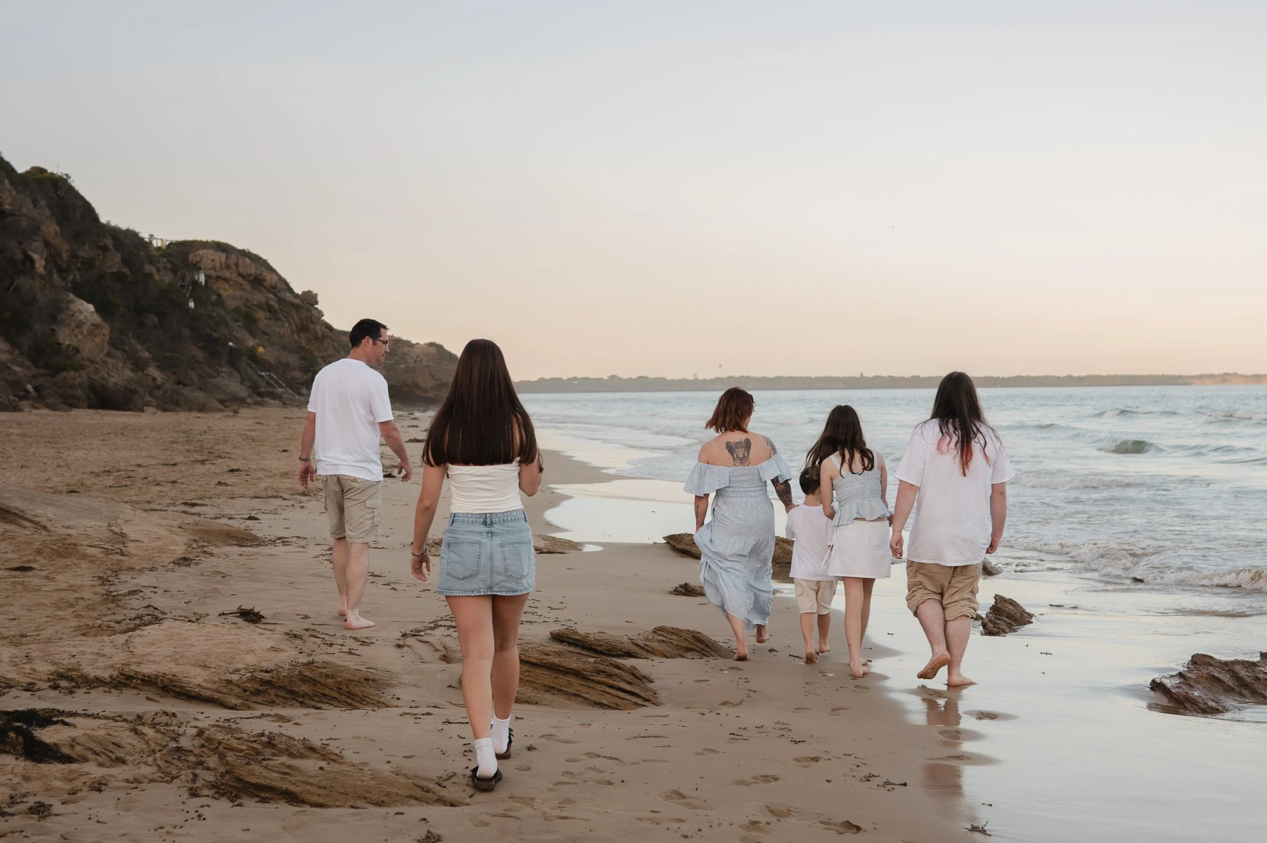 Family walking a a beach in Melbourne during a family photo session