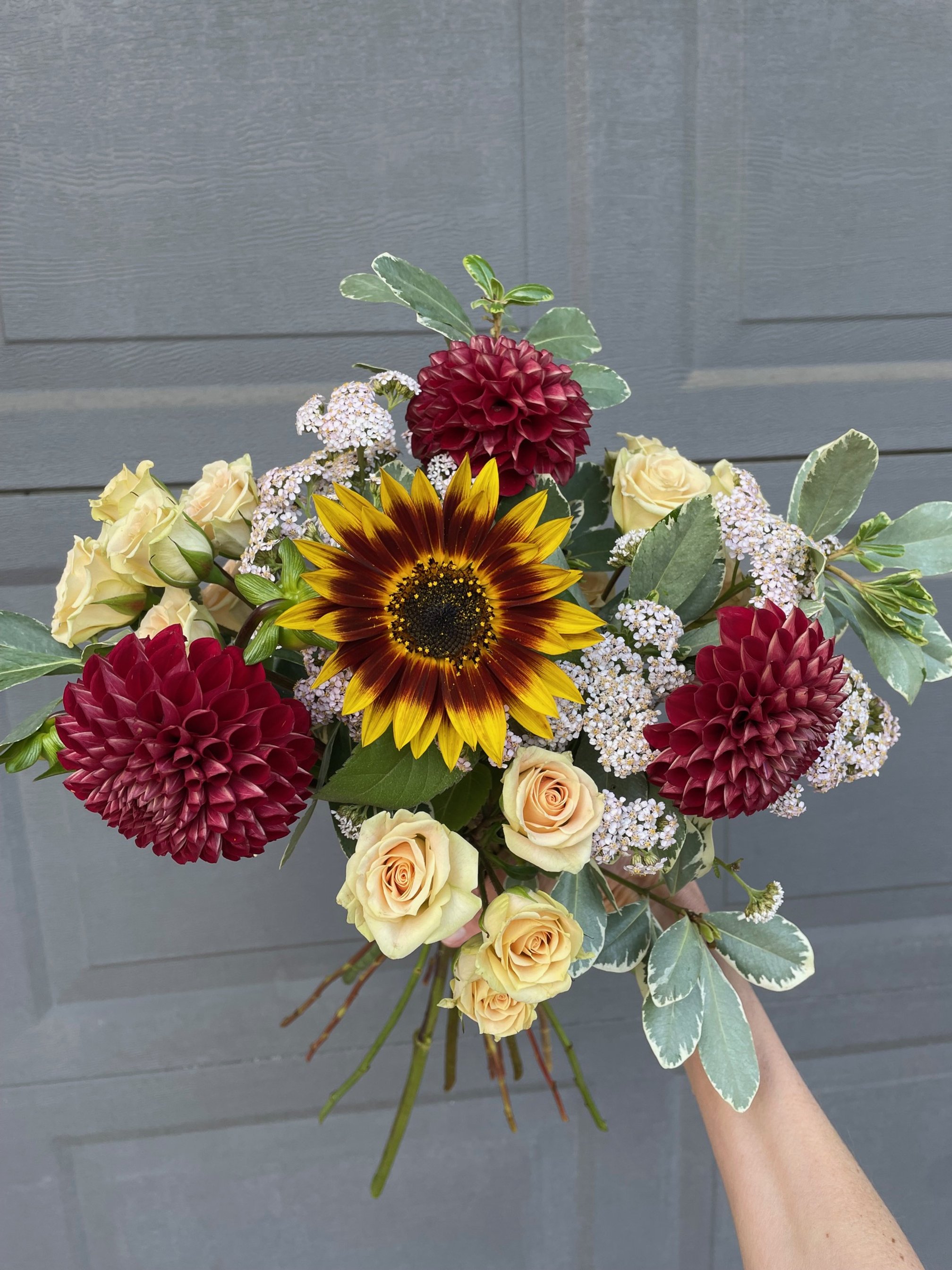What’s the difference between a deluxe arrangement, hand-tied bouquet, and a mini arrangement?