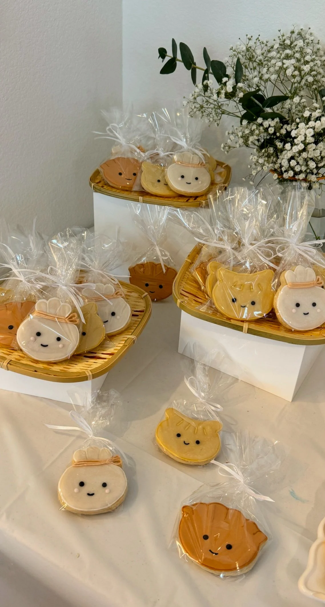 Hand-decorated sugar cookies shaped like dumplings, complete with custom icing detail