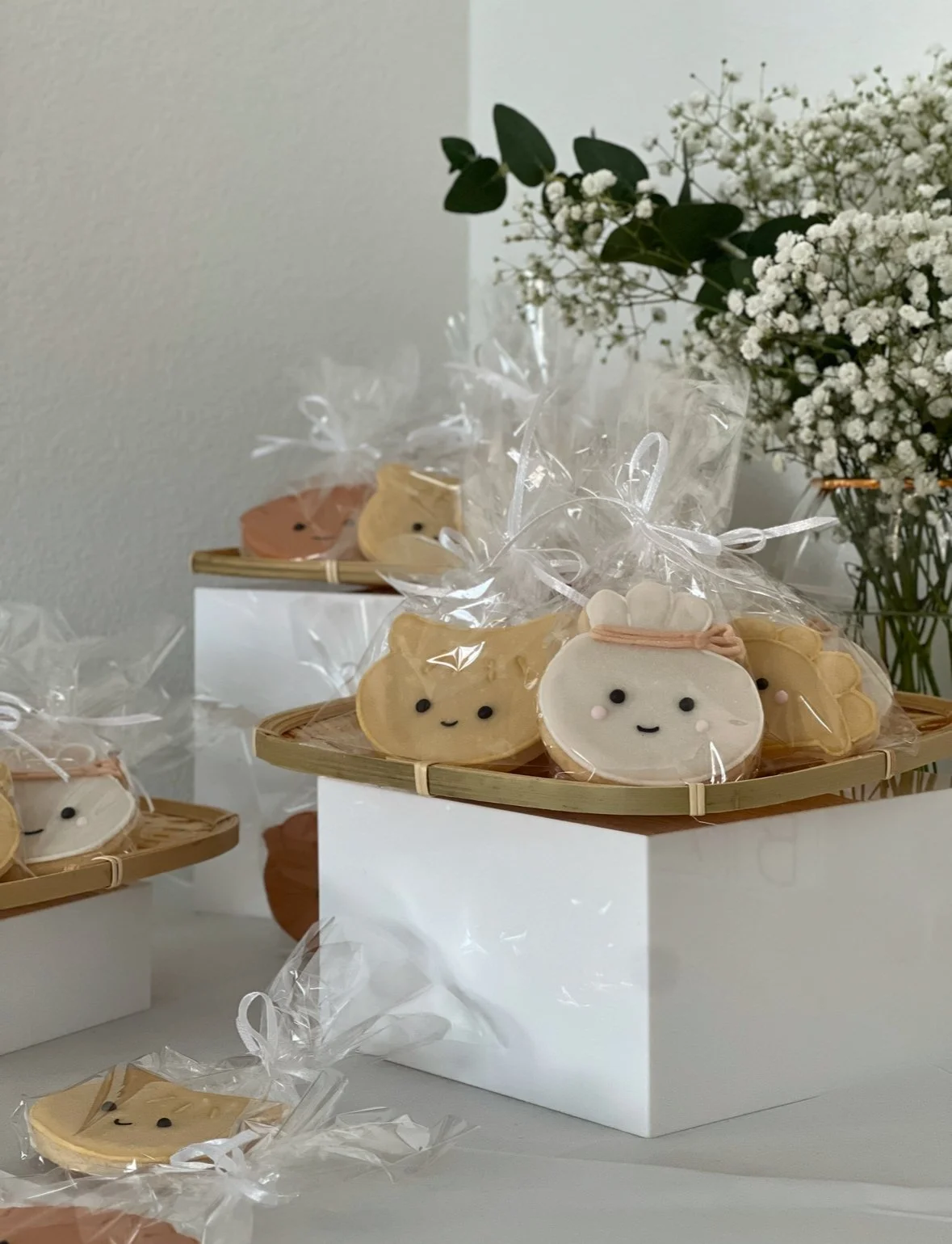 Hand-decorated sugar cookies shaped like dumplings, complete with custom icing detail