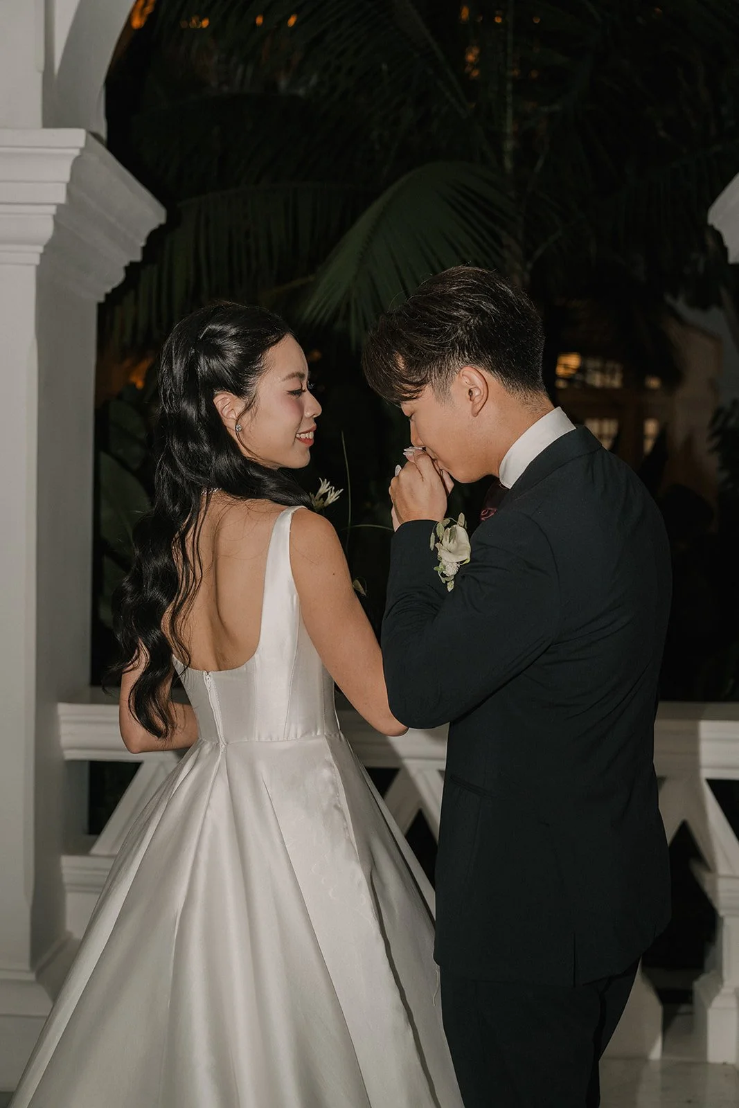 Bride and groom sharing a quiet moment during evening portraits at Raffles Hotel Singapore