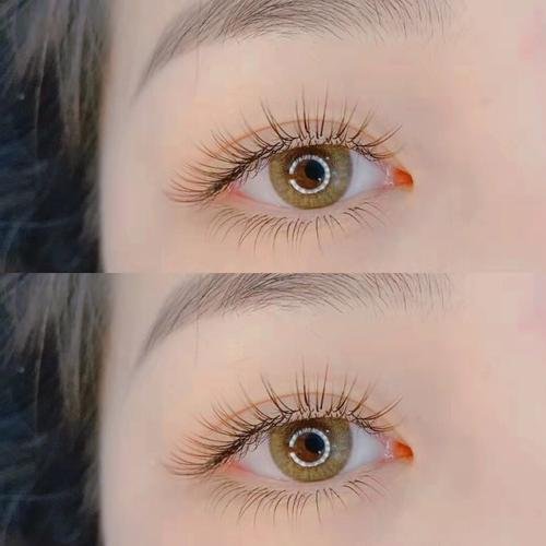 Close-up of two brown eyes with long eyelashes.