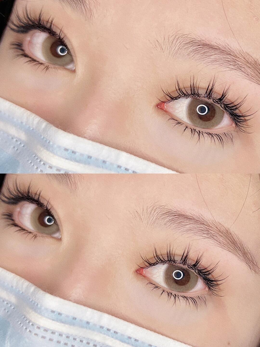 Close-up of eyes with long eyelashes above a face mask.