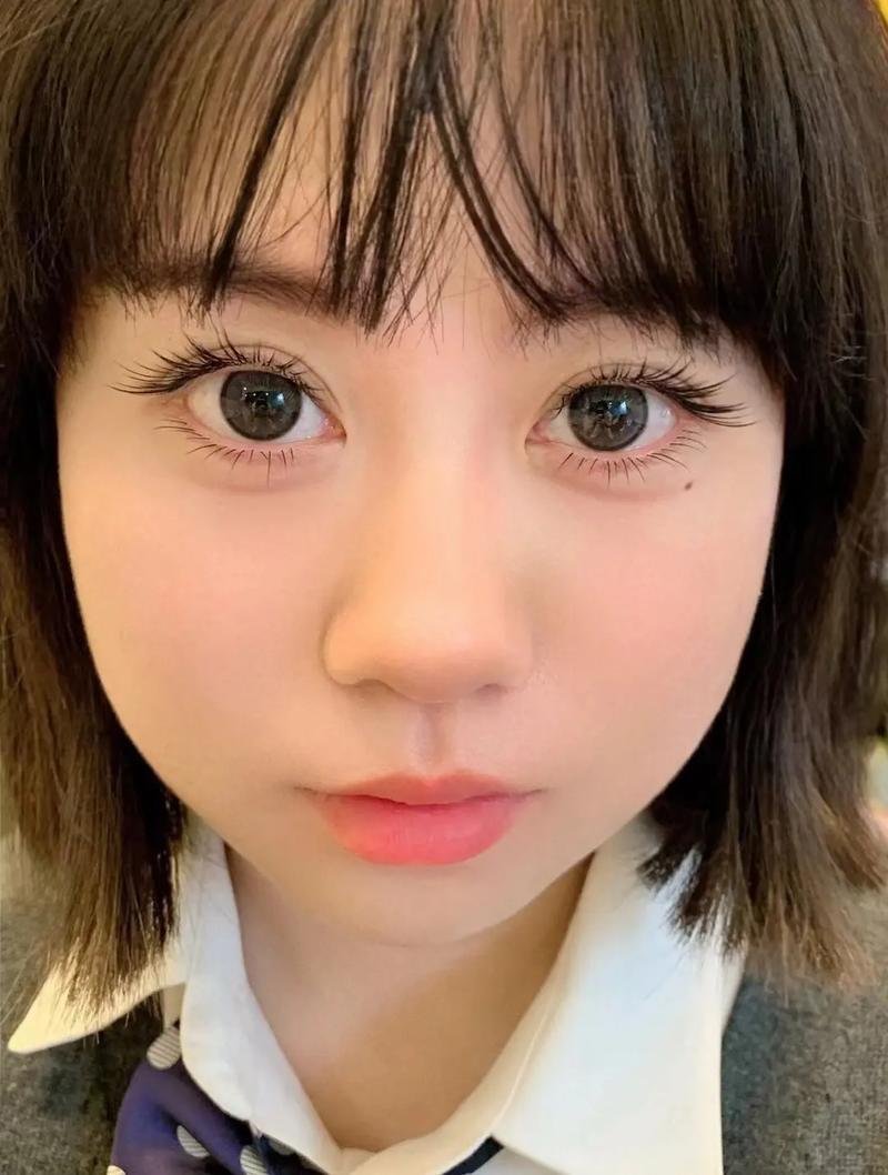 close-up of a person with dark hair and bangs