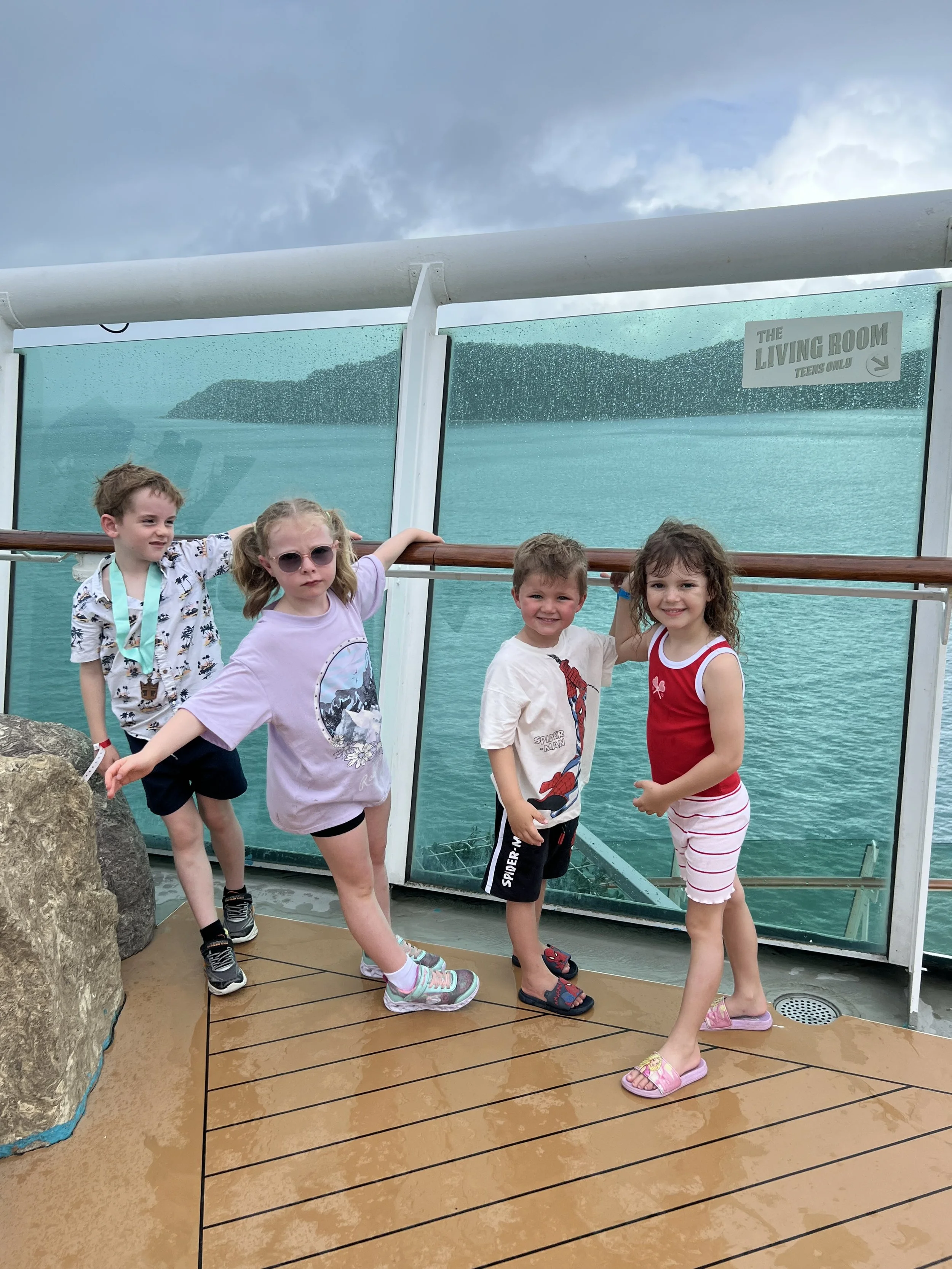 Kids on the deck of a cruise ship during a family world schooling trip