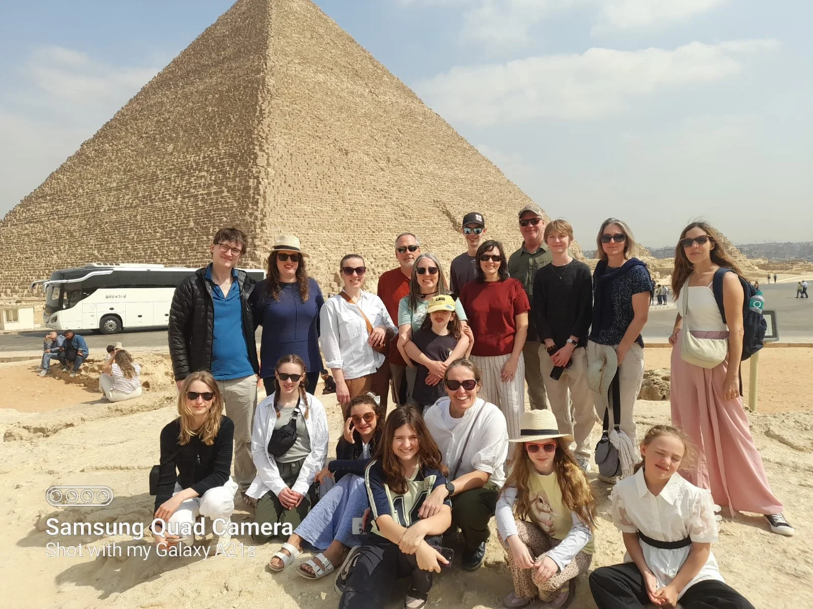 Families on a World School Camp group trip posing together in front of the Great Pyramid of Giza, Egypt