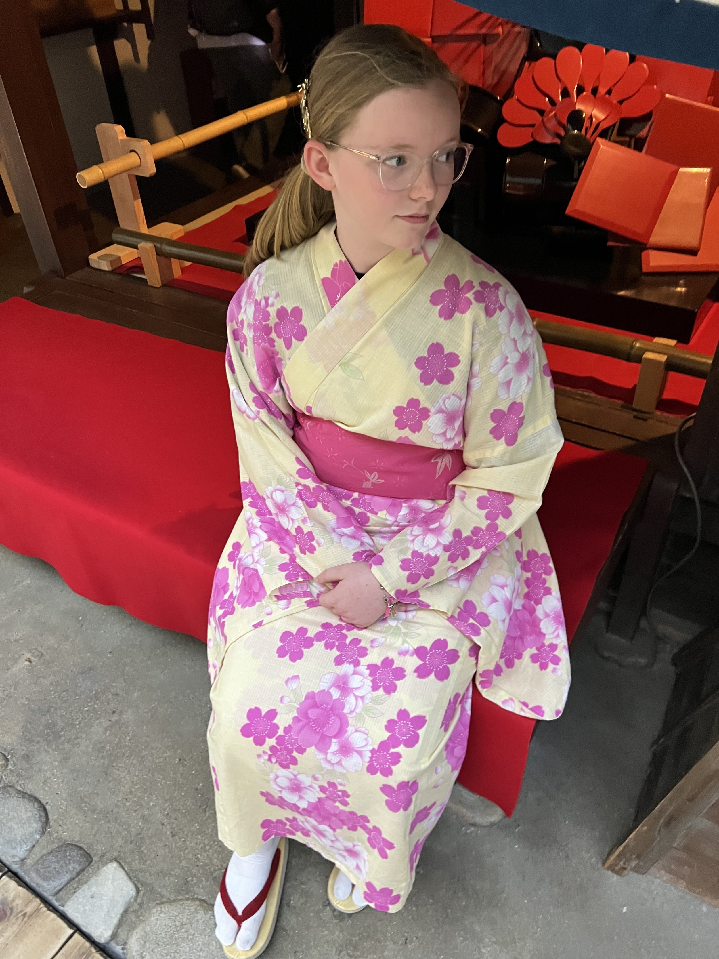 Worldschooling girl wearing a pink floral yukata in Japan