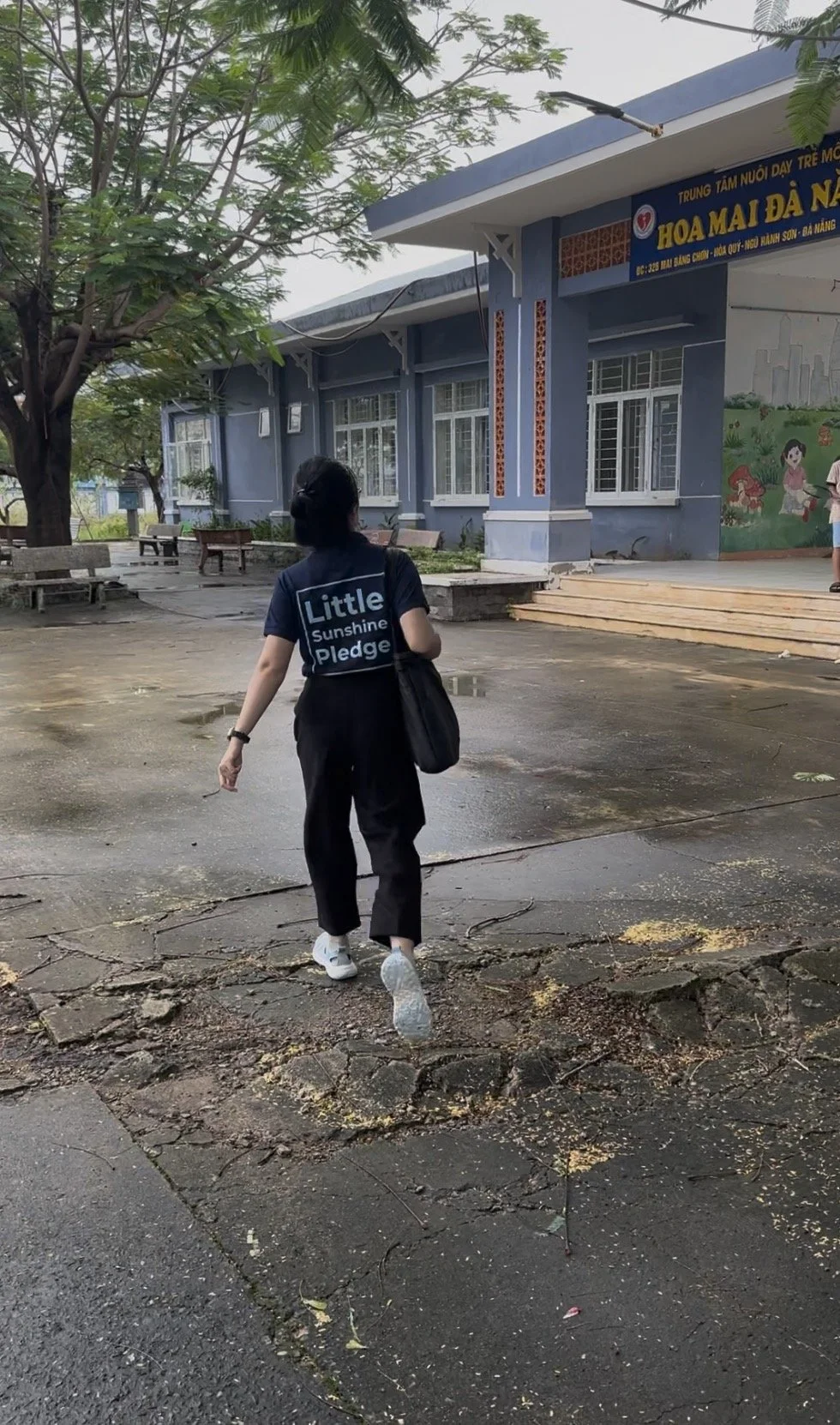 Little Sunshine Pledge team member walking through the grounds of Hoa Mai orphanage during a site assessment visit