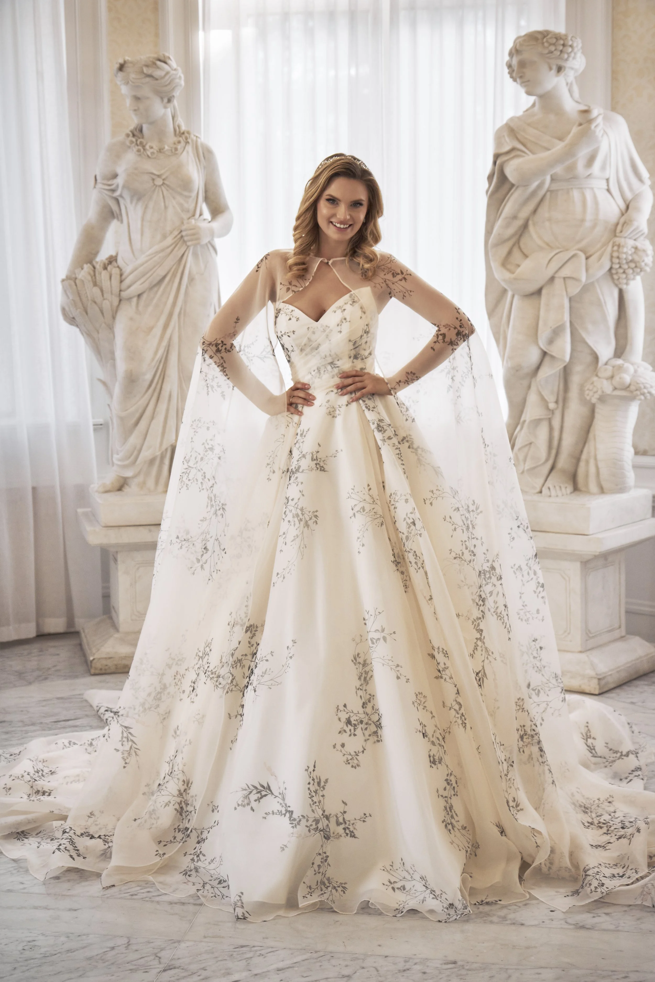 Front view of Lia Bella Model Therese showing the strapless sweetheart bodice and matching botanical-print cape.