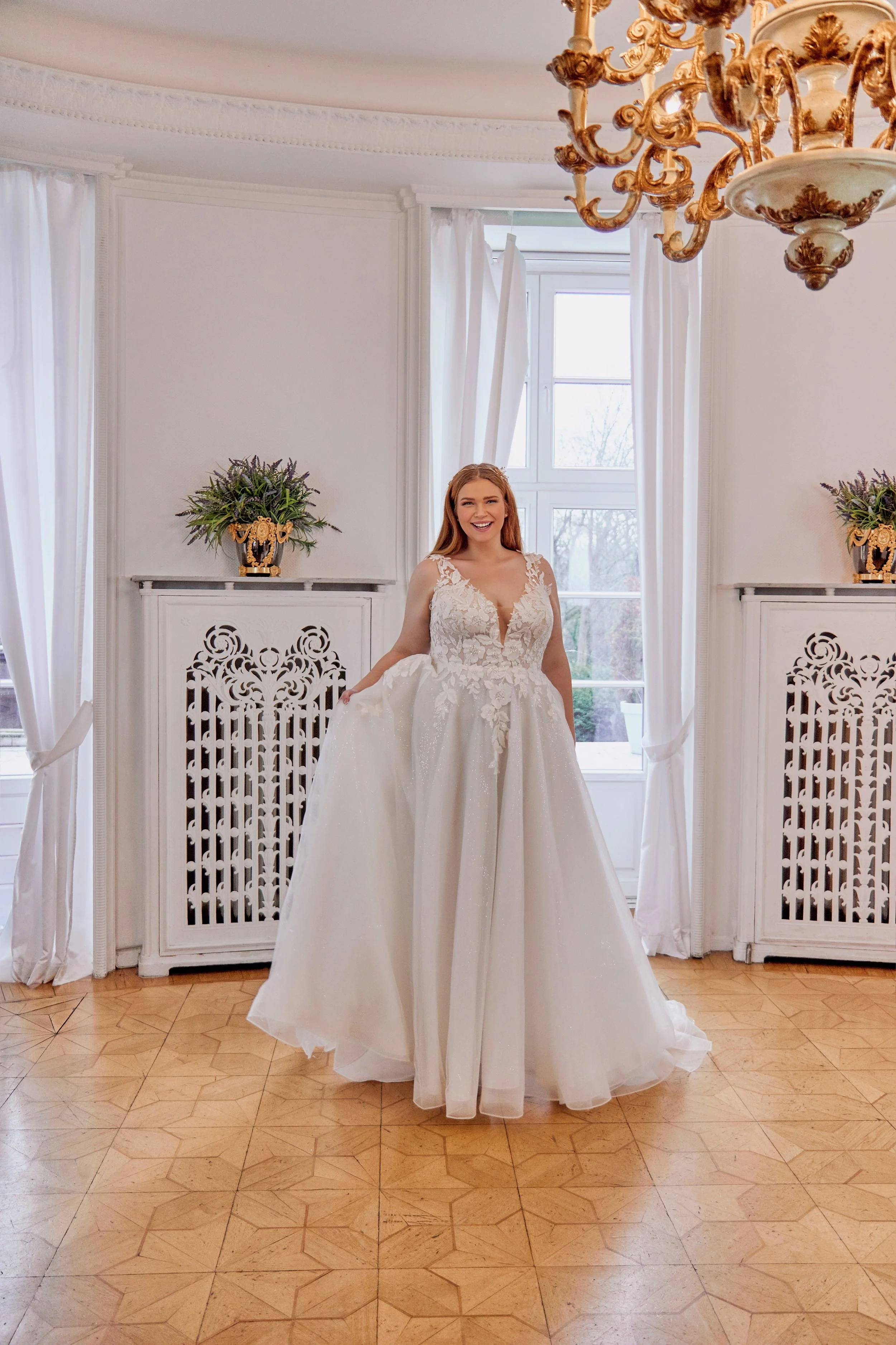 Full-length front view of Lia Bella Model Tovi, a curvy A-line wedding dress with three-dimensional floral lace and a shimmering tulle skirt.