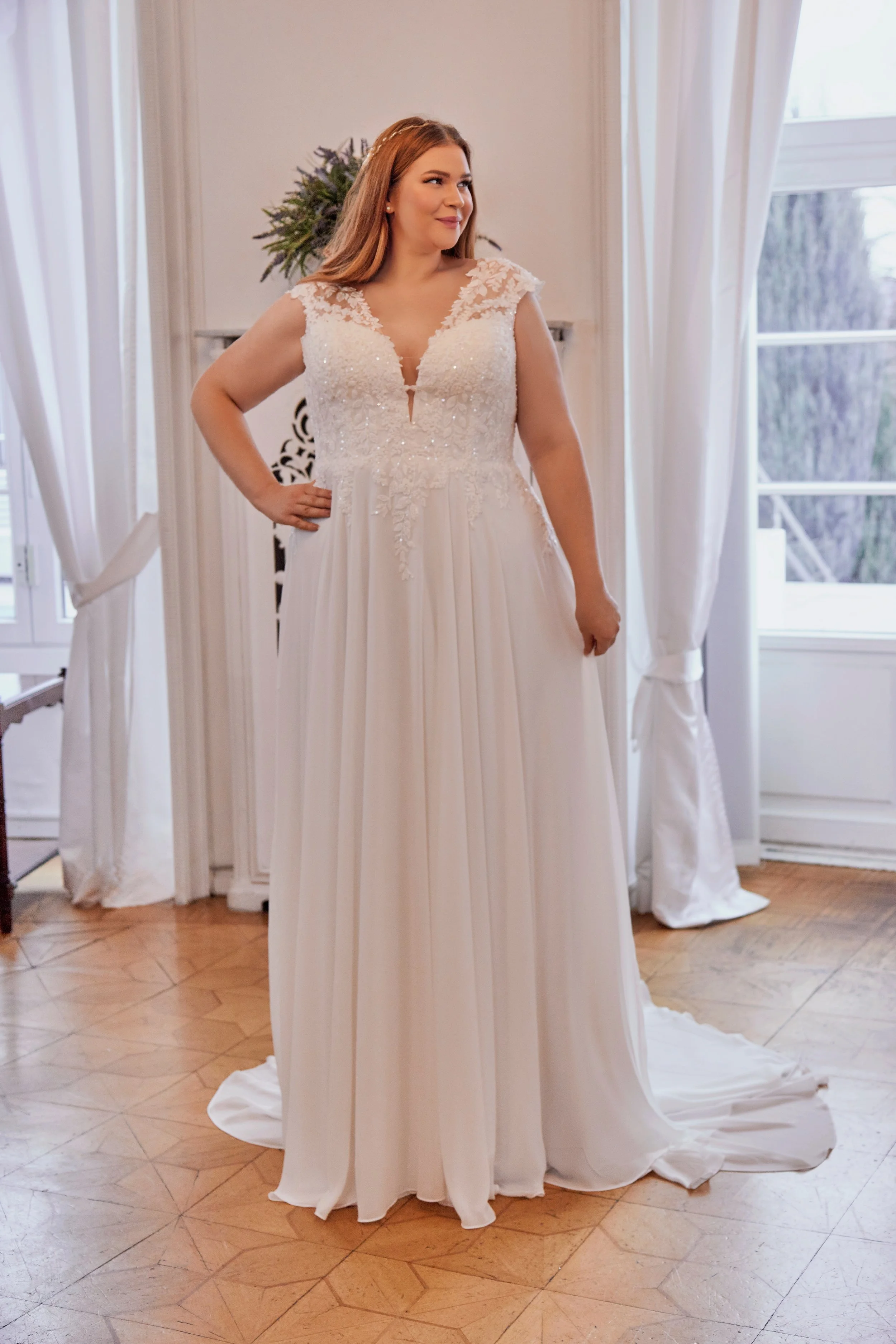 Three-quarter front view of Lia Bella Model Tracy featuring the embellished lace bodice and softly draped chiffon A-line skirt.