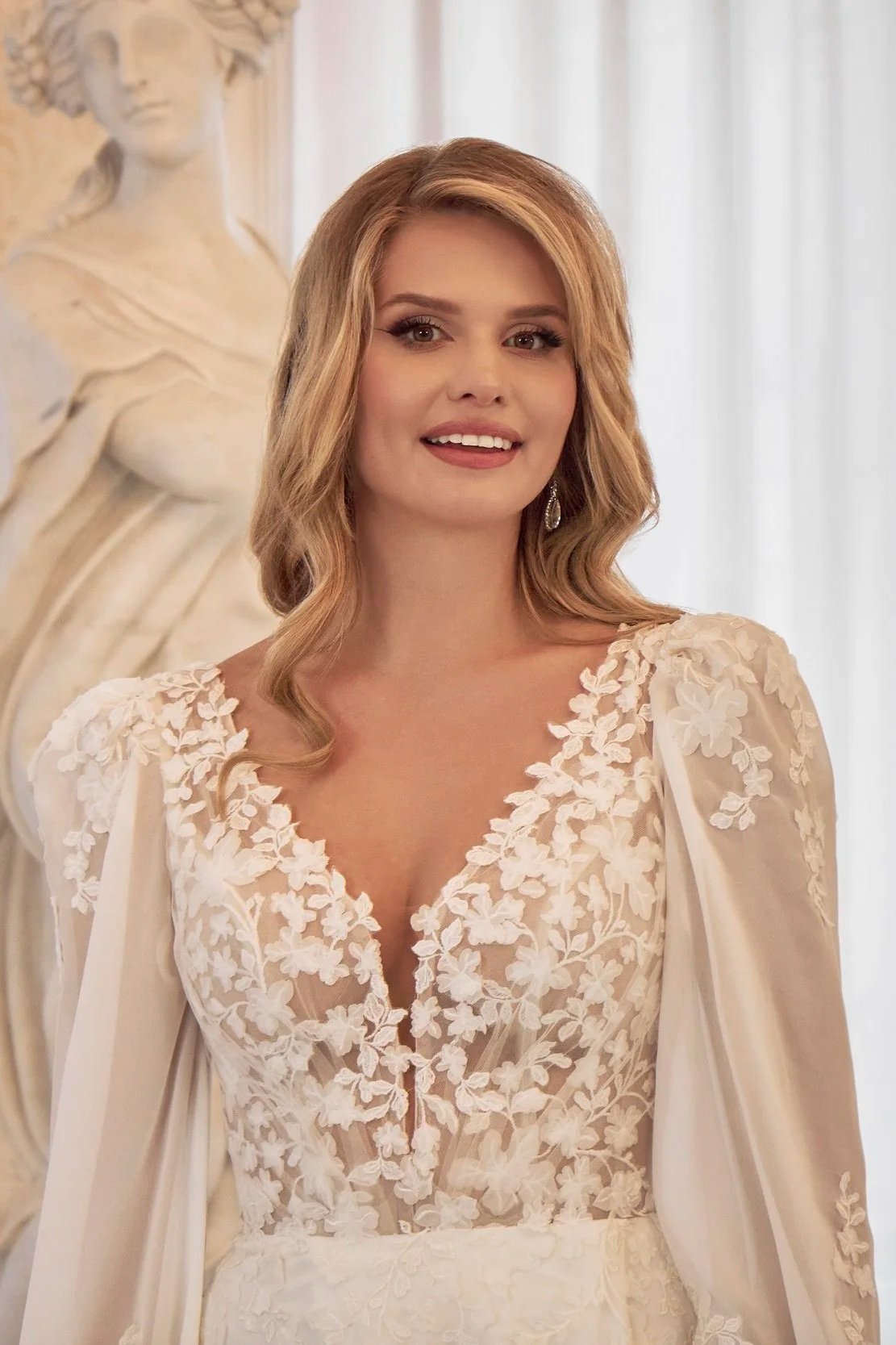 Front detail of Lia Bella Model Tiliane highlighting the floral lace bodice and romantic sheer bishop sleeves.