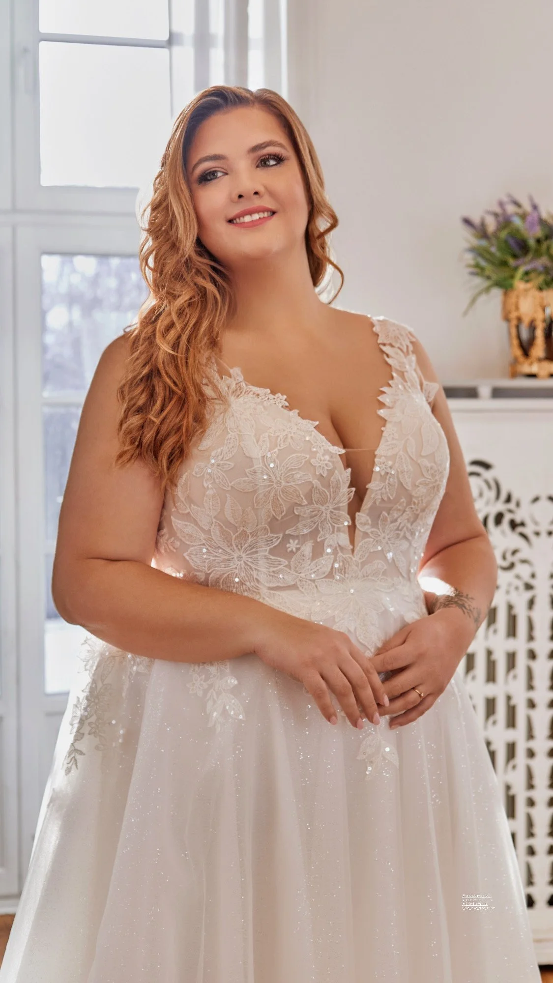 Close-up of Lia Bella Model Trudy highlighting the deep V-neckline, illusion inset and delicately sequined floral lace bodice.