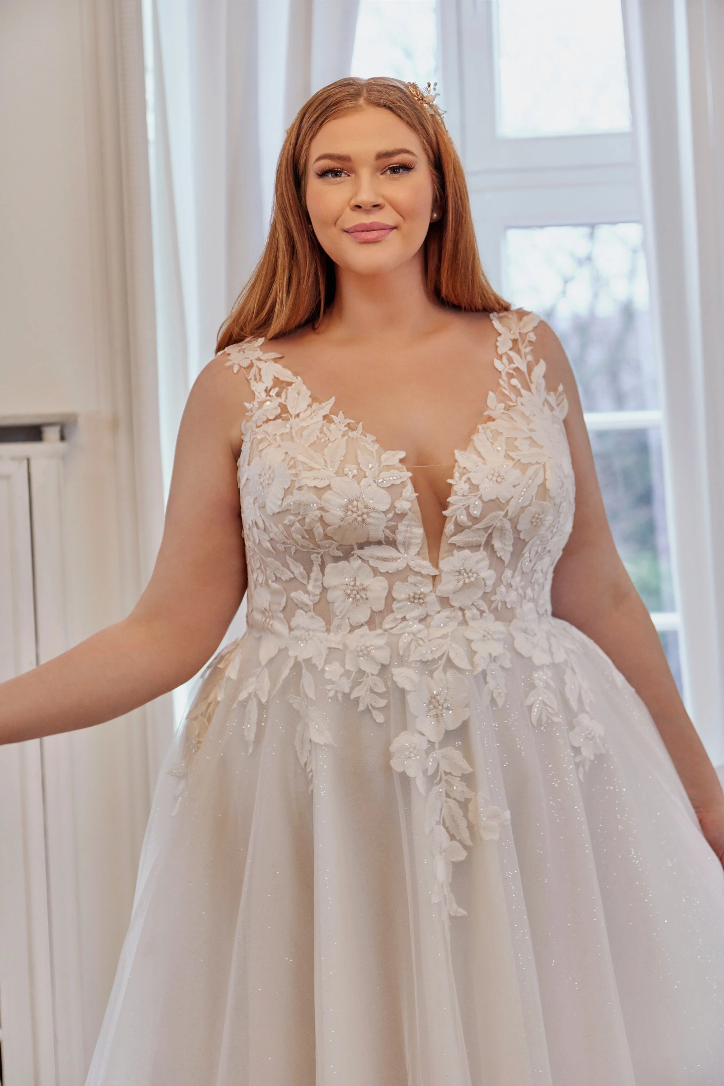 Close-up of Lia Bella Model Tovi highlighting the deep V-neckline, illusion inset and three-dimensional floral appliqués with beaded details.