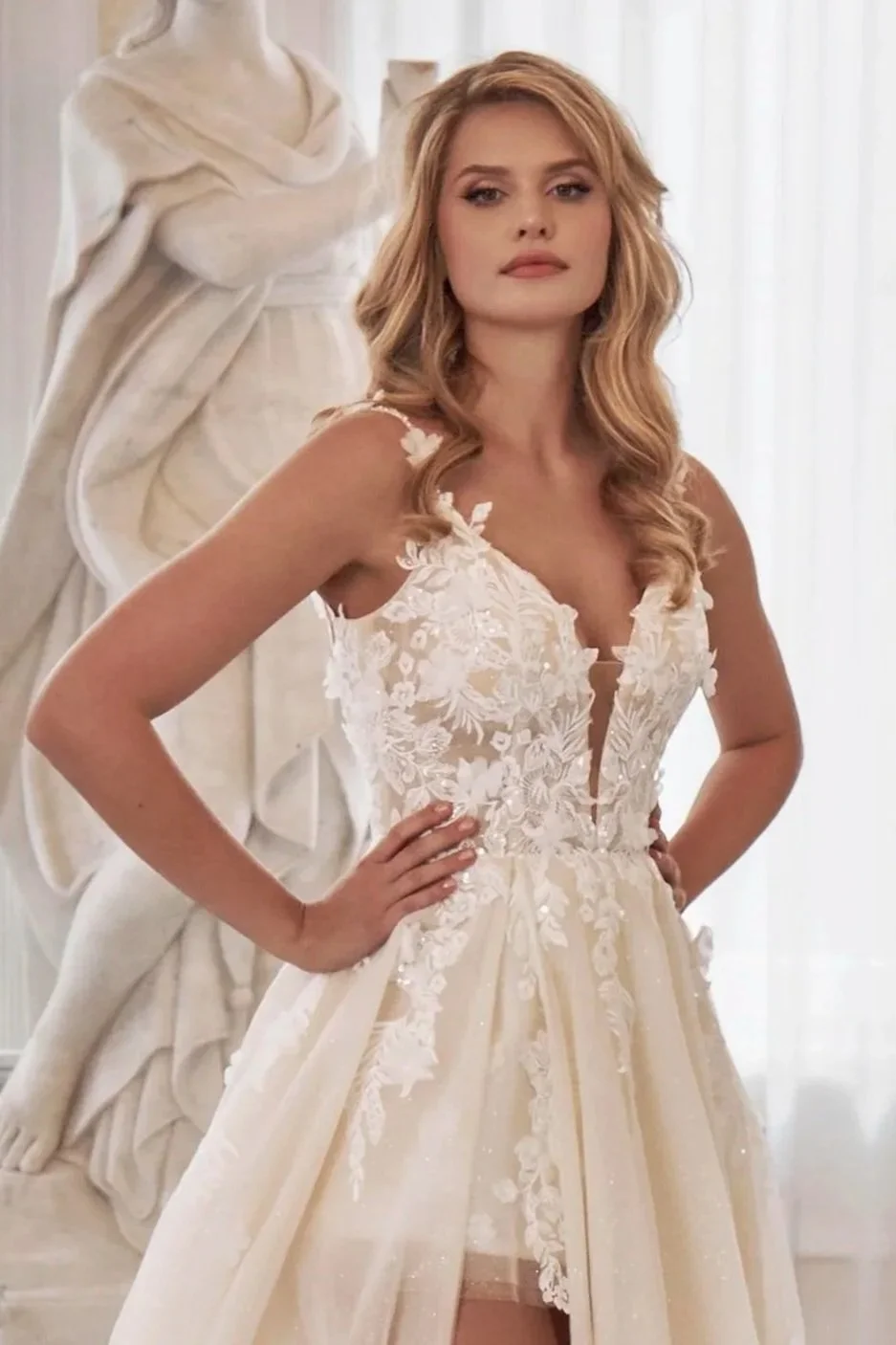 Three-quarter front view of Lia Bella Model Tizia highlighting the floral lace bodice, plunging V-neckline and high side slit.
