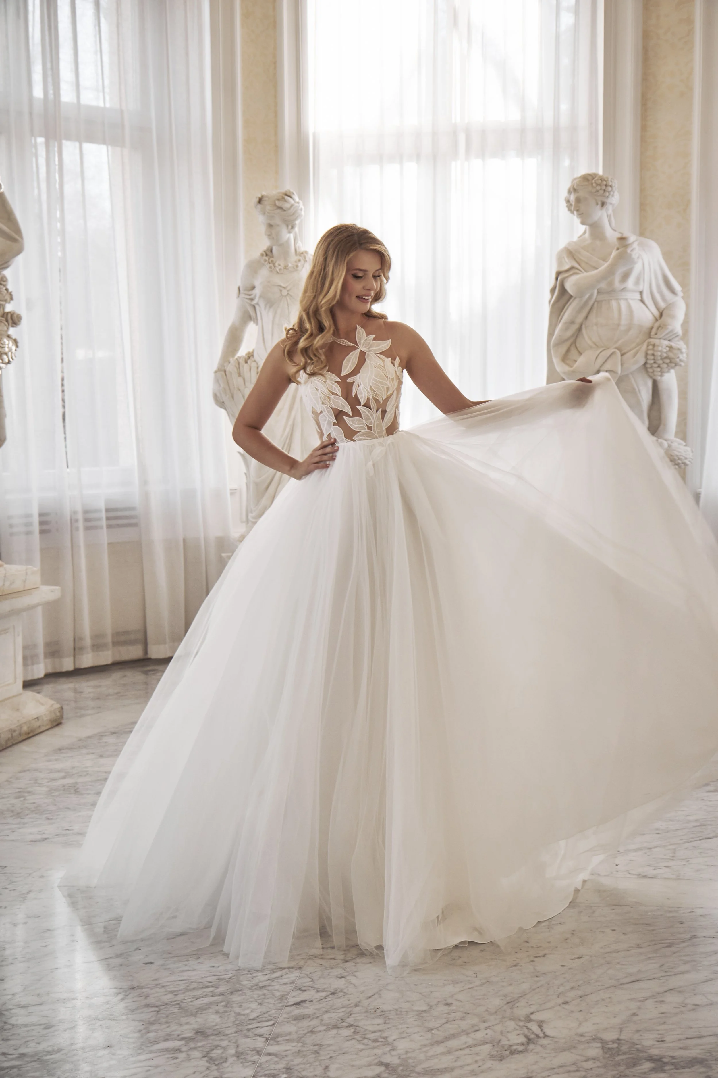 Full front view of Lia Bella Model Tamina, a tulle ball gown wedding dress with an illusion bodice and botanical leaf lace.