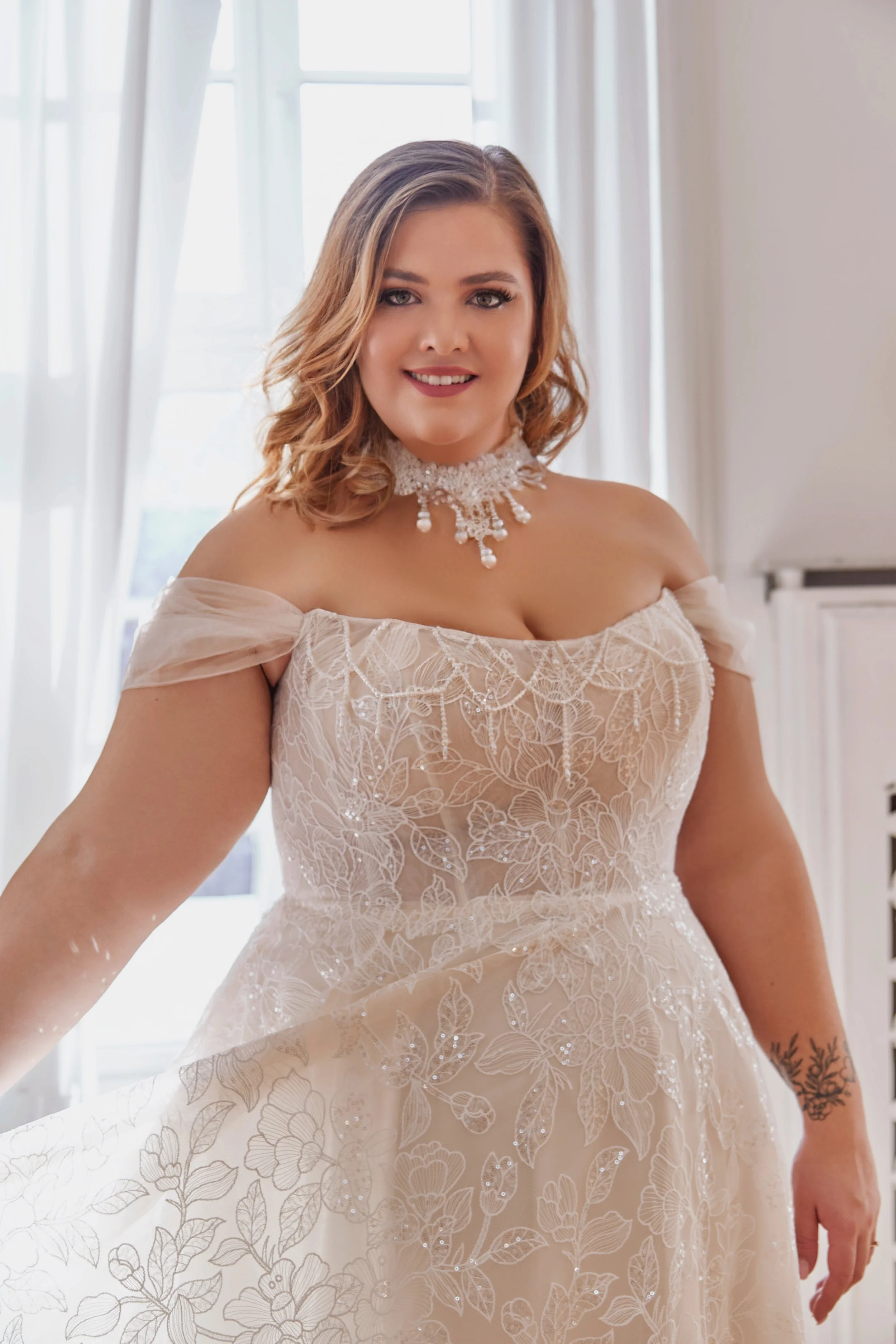 Close-up of Lia Bella Model Temea highlighting the structured lace bodice, curved neckline and delicate beaded draping.