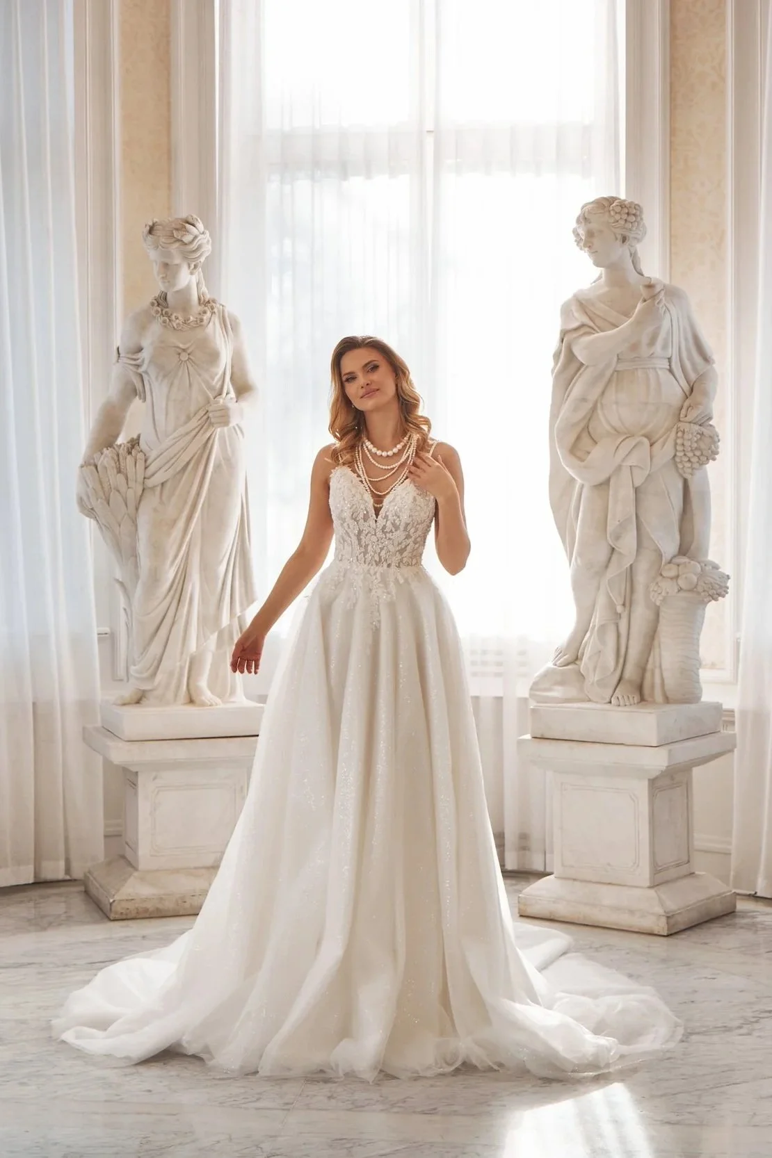 Lia Bella Model Tasha in motion, highlighting the flowing A-line silhouette and softly shimmering tulle skirt.