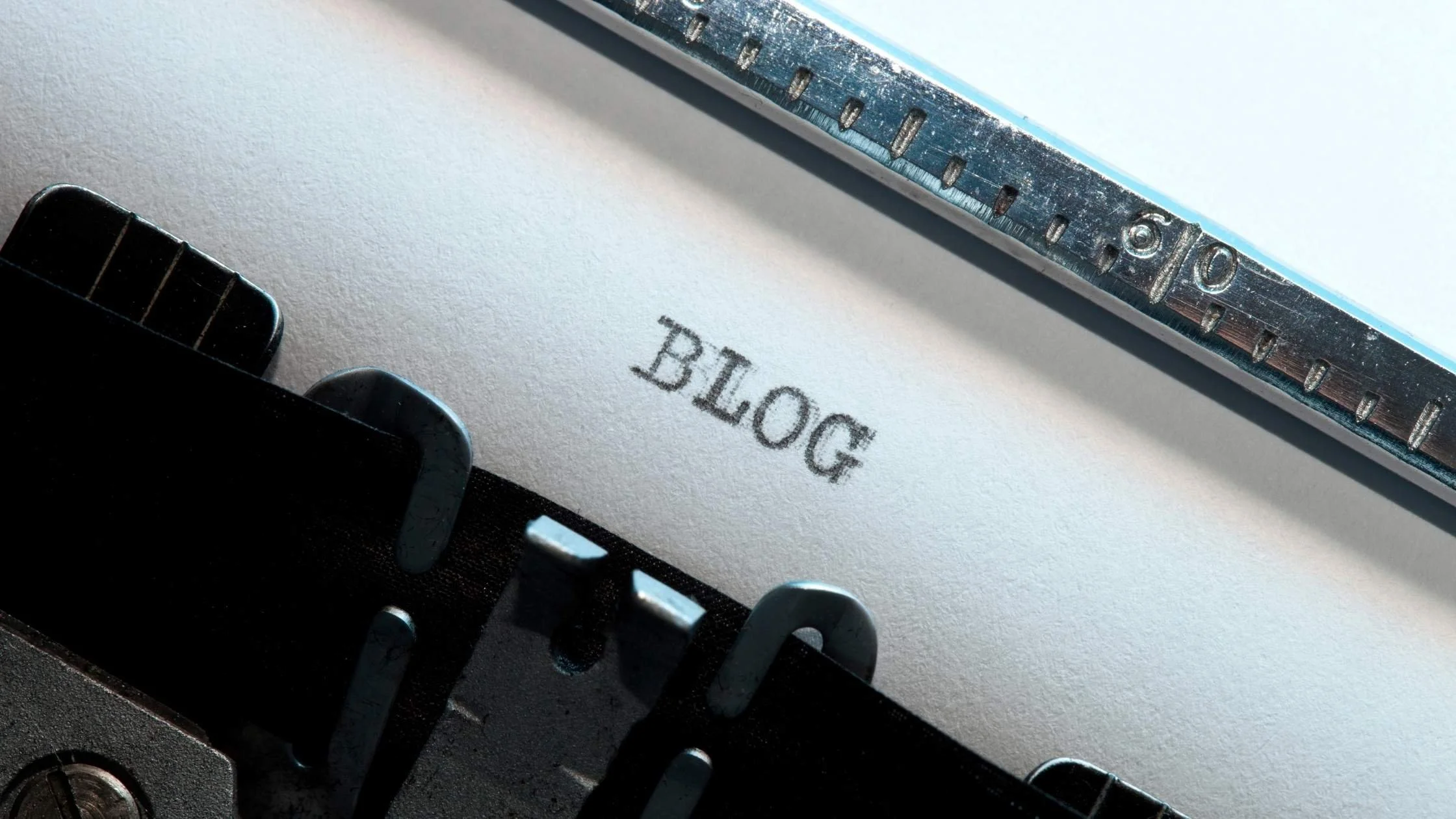 Close-up of a typewriter with the word 'BLOG' typed on the page, representing blog writing and content creation.
