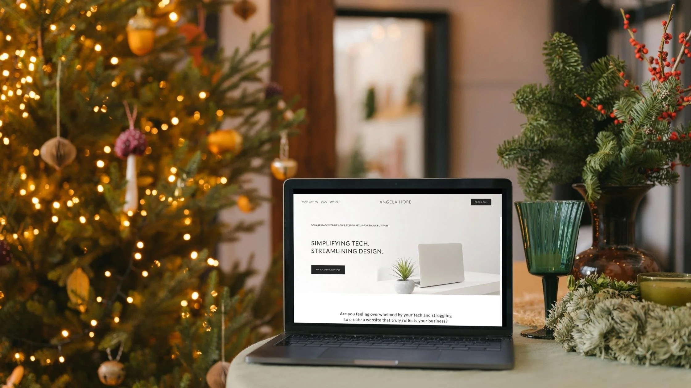 Minimalist Squarespace website on a laptop with a Christmas tree in the background, perfect for quick website updates before year-end.