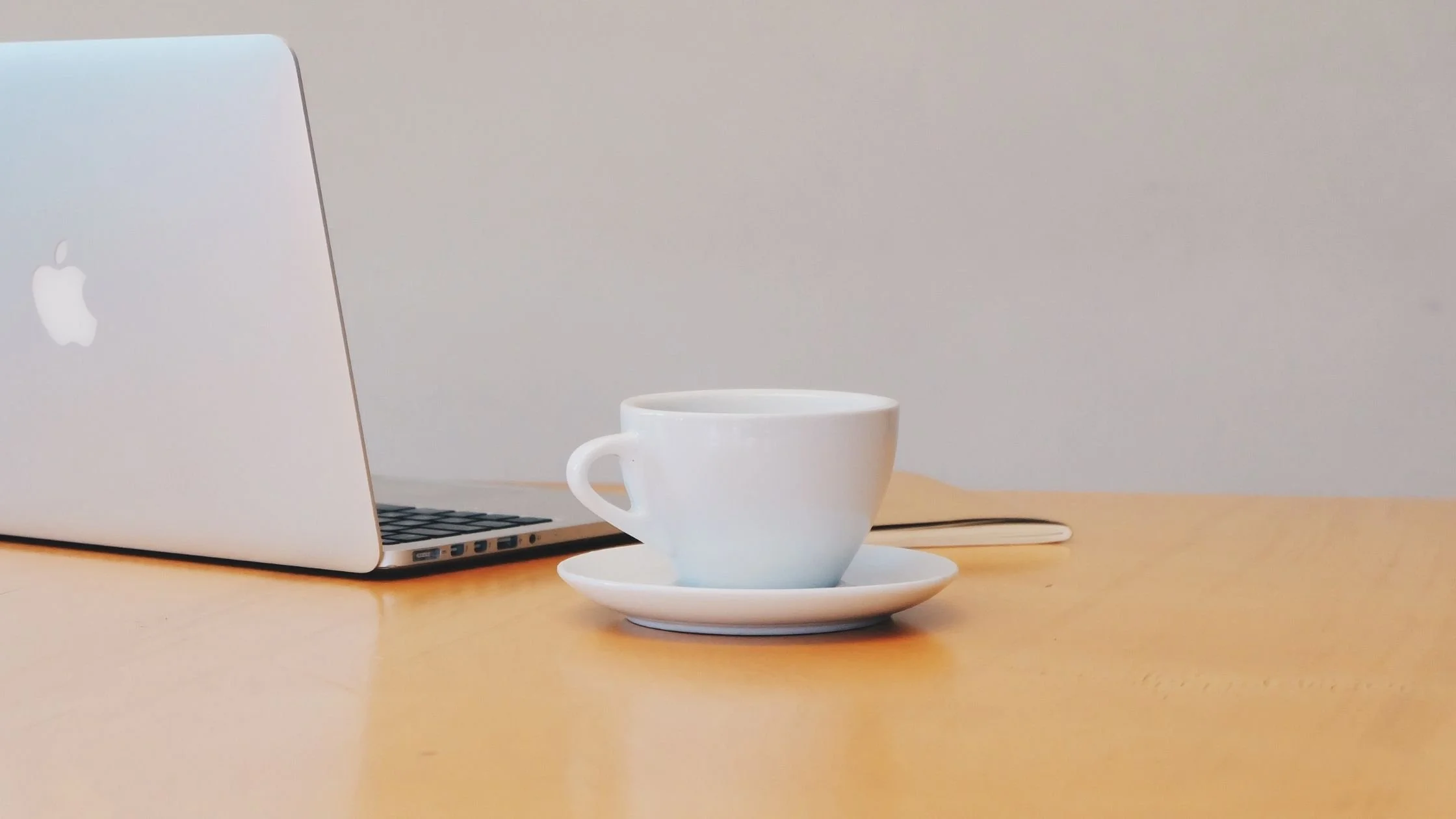 Minimal workspace with Apple keyboard and notebook representing productivity tips and keyboard shortcuts