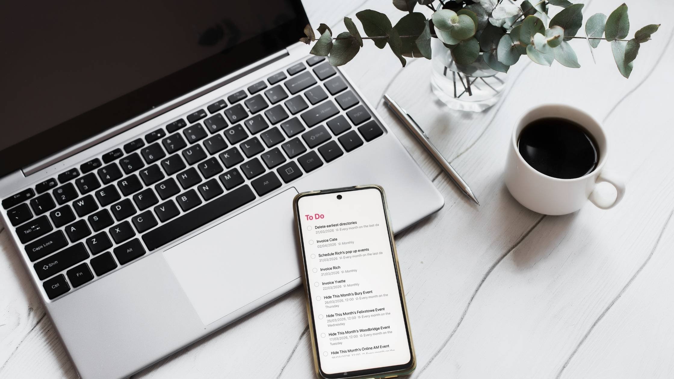 Flatlay of laptop, coffee, and phone showing a to-do list for a simple project workflow