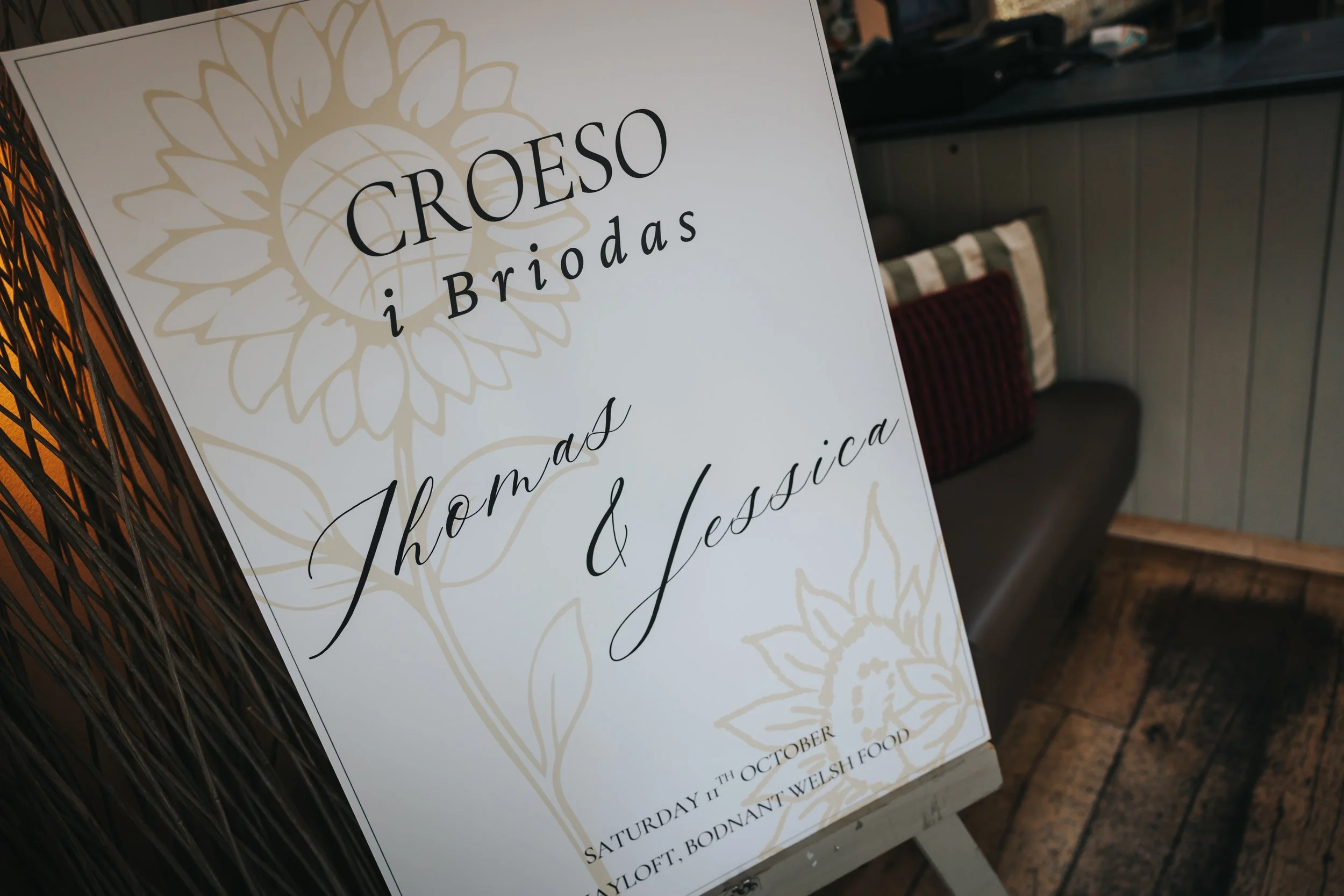 Sign advertising a floral and Welsh food event at a restaurant, dated Saturday, October 11, in Llangollen, Bodnant Welsh Food.