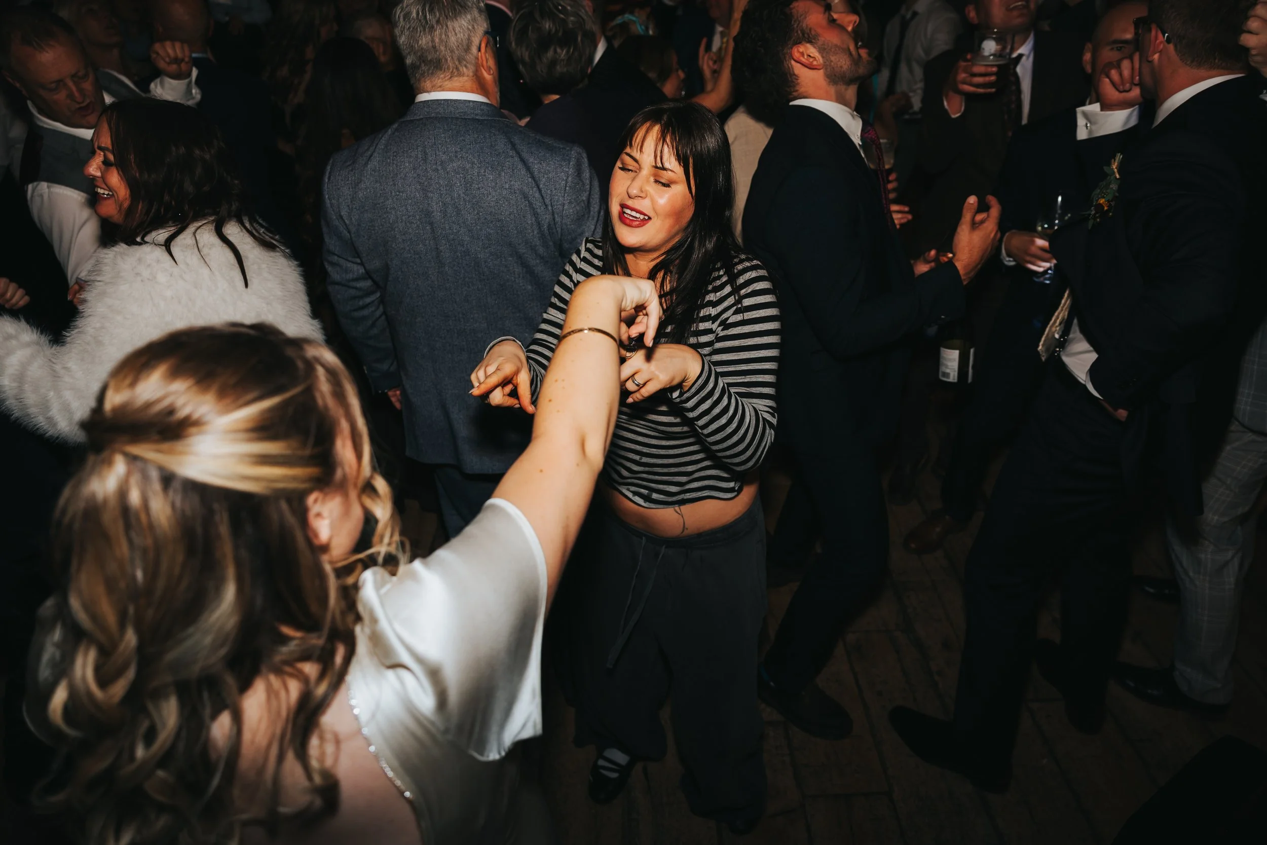 People dancing and socializing at a lively party or celebration.