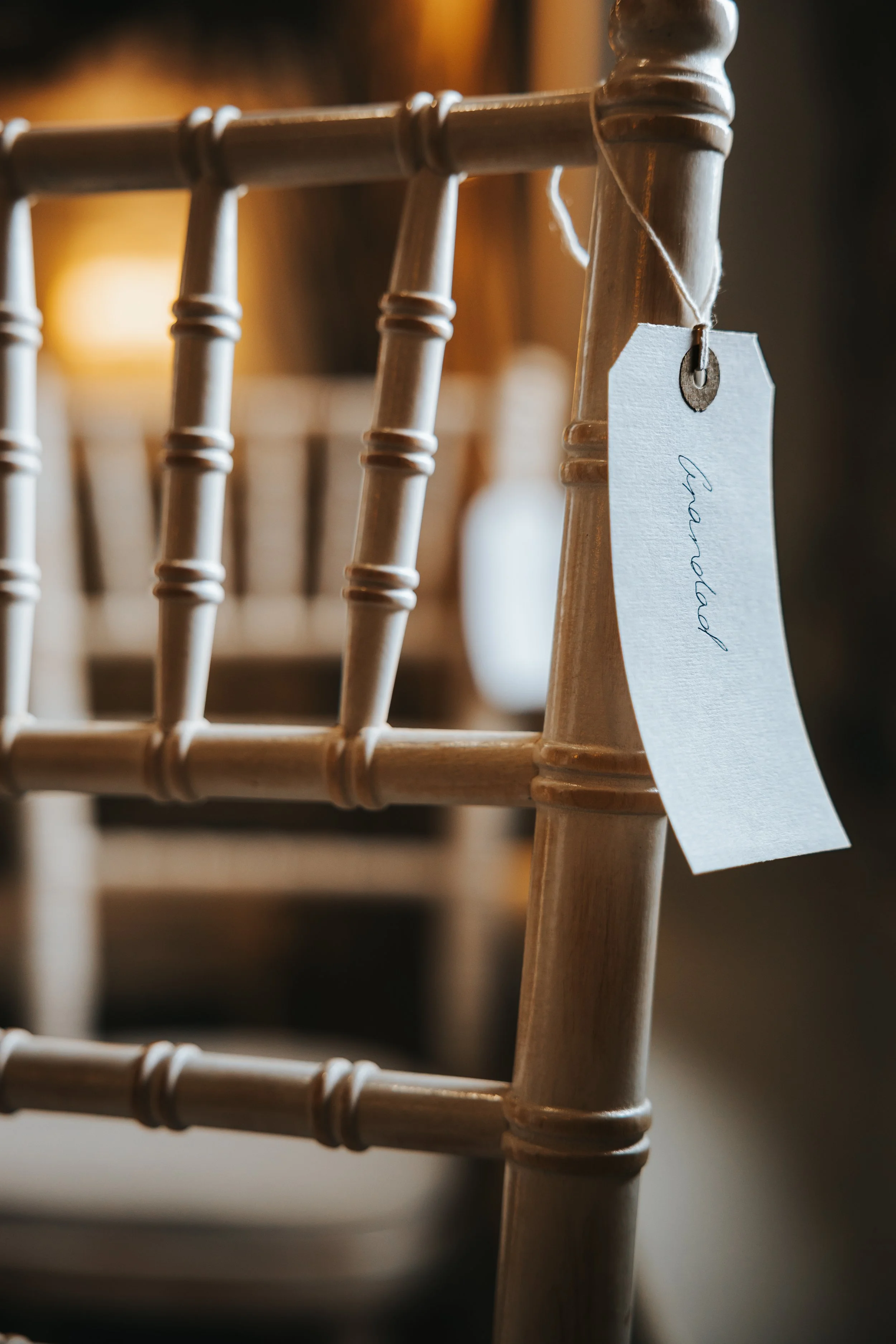 A wooden chair with a handwritten 'Thankful' note hanging from the backrest.