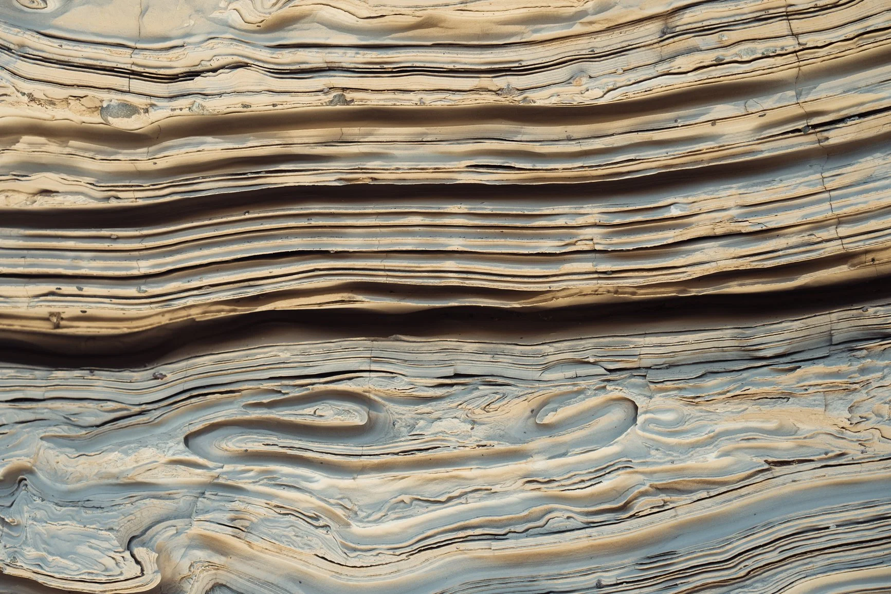 Close-up of sedimentary stone layers in warm tones