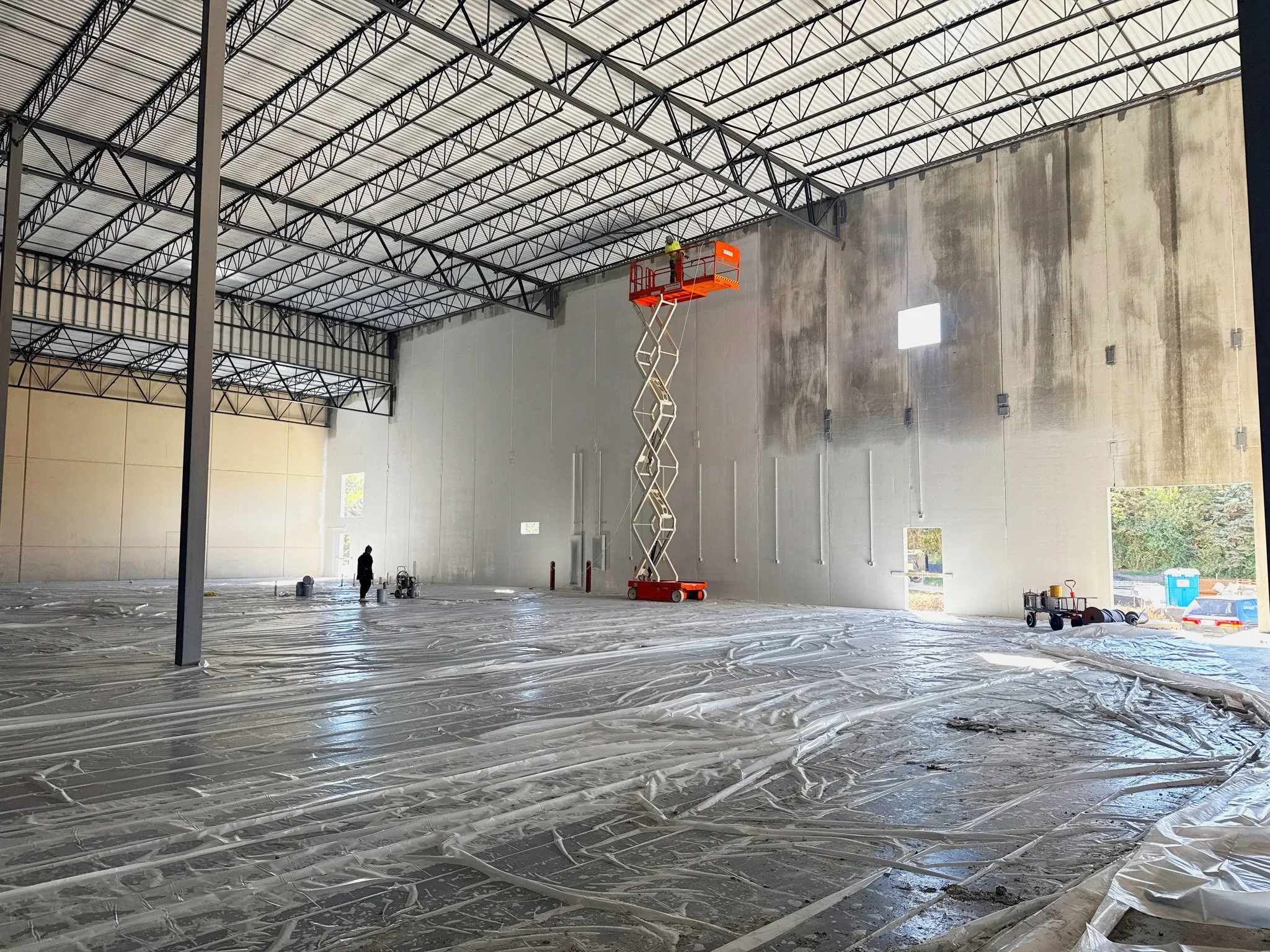 Good contractors pride themselves on using a curing compound for a few days and call it a win when the floor is 95% crack-free. Great contractors take the time to damp cure under visqueen for a full 28 days, delivering a 100% crack-free floor without