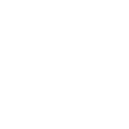 Line of stacked shipping containers with three trucks parked behind them