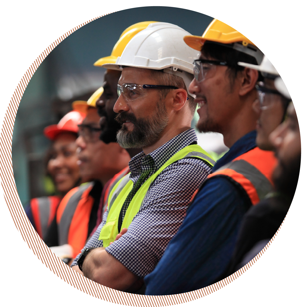 Group of construction workers wearing safety helmets and reflective vests attending a meeting or presentation.