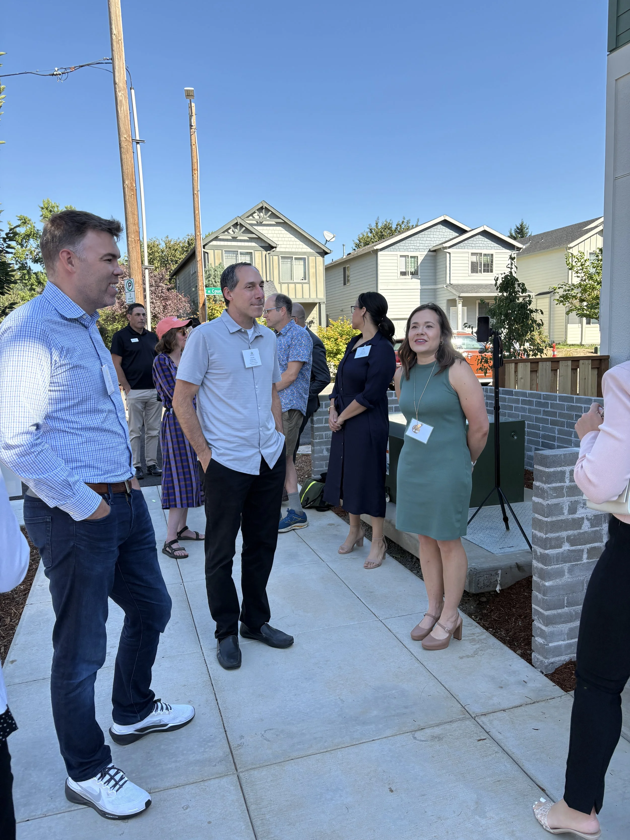 Chris Henderson, Habitat for Humanity President and CEO Steve Messinetti, and Proud Ground Real Estate Project Associate Katie Parano-Friesen