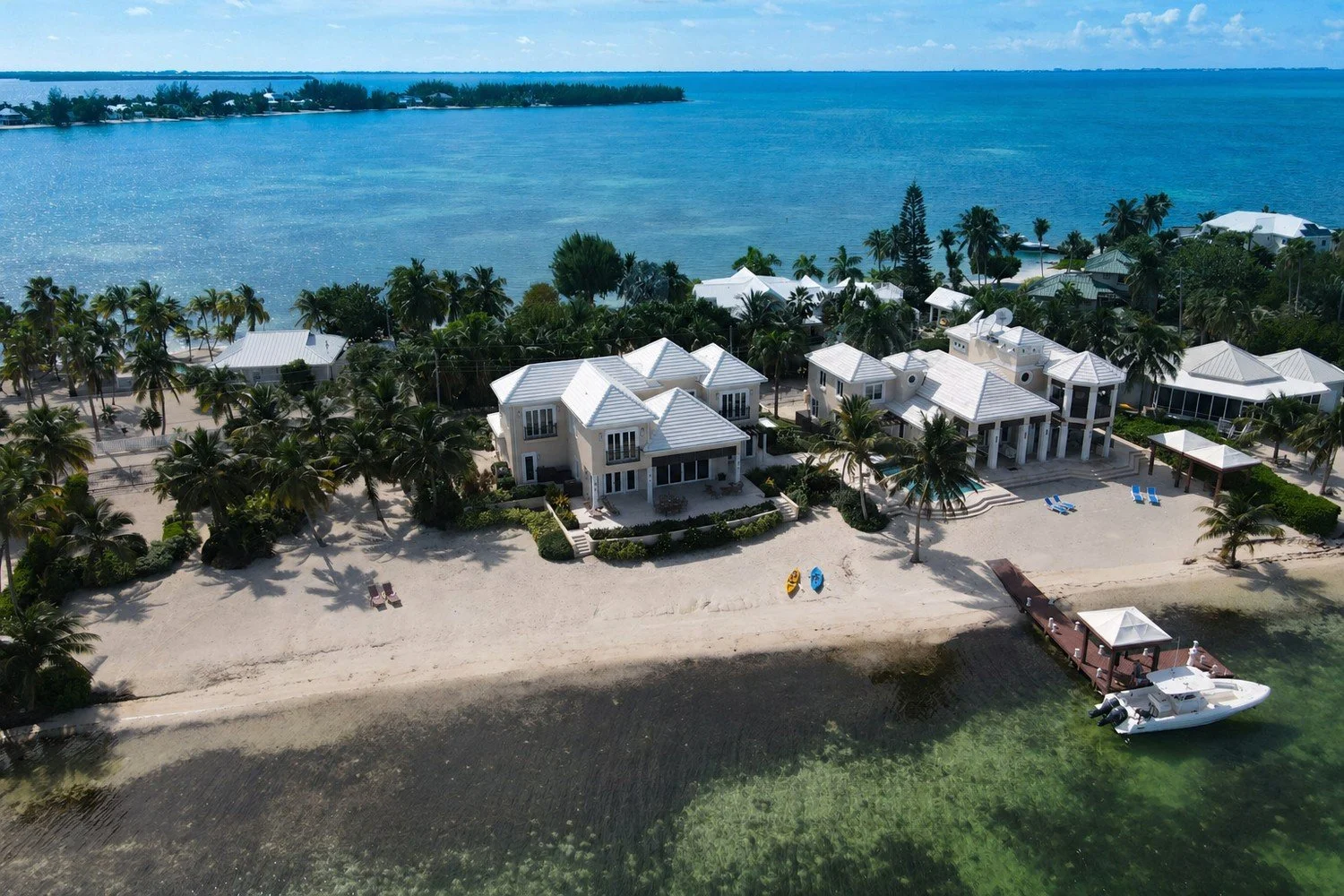 Aerial drone view of a multi building beachfront property in Cayman