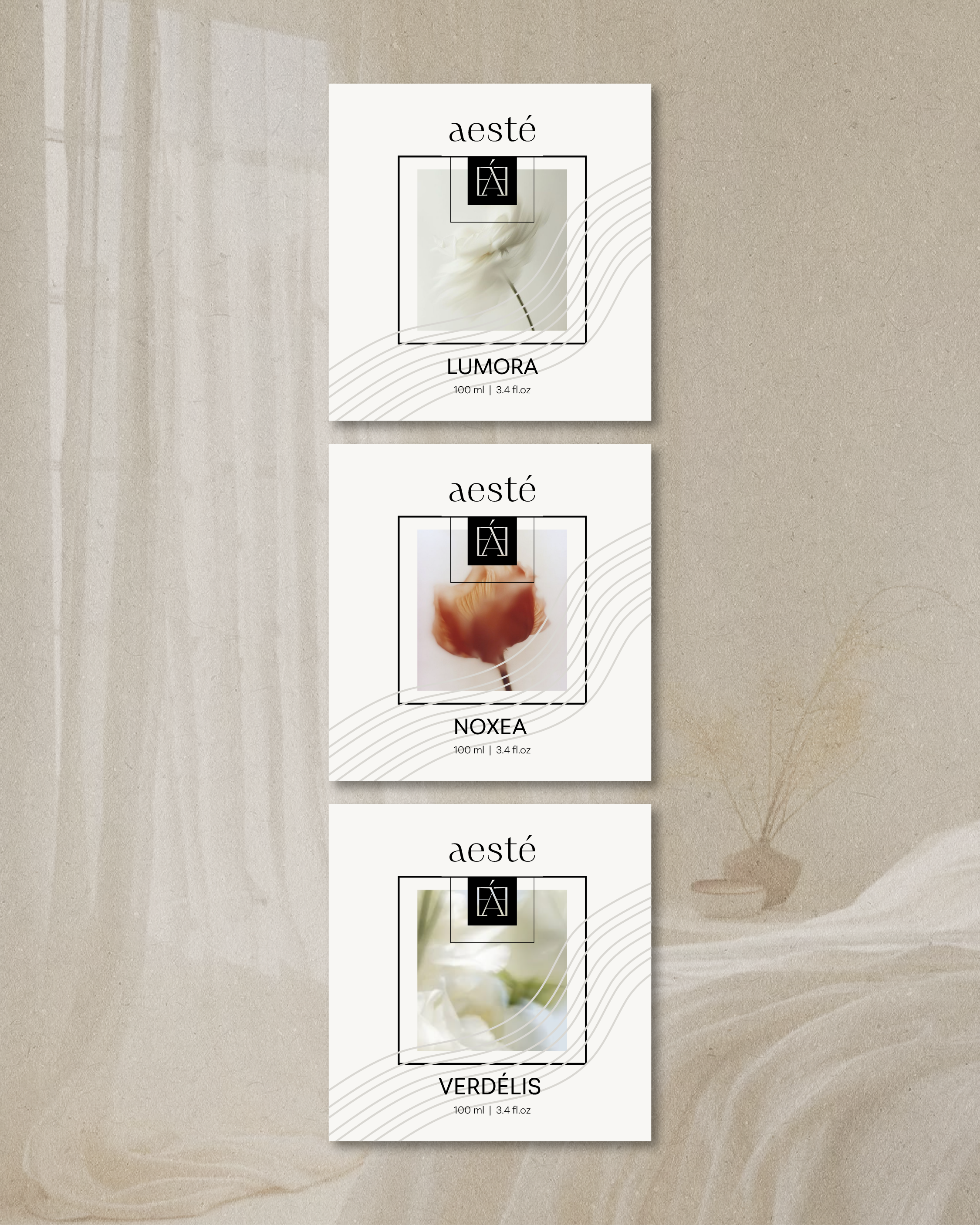 Three perfume boxes with white backgrounds and black logos. The top box labeled 'LUMORA', the middle one 'NOXEA', and the bottom one 'VERDÉLIS'. Each box has a blurred floral image behind a square outline and the brand name 'aesté' at the top.