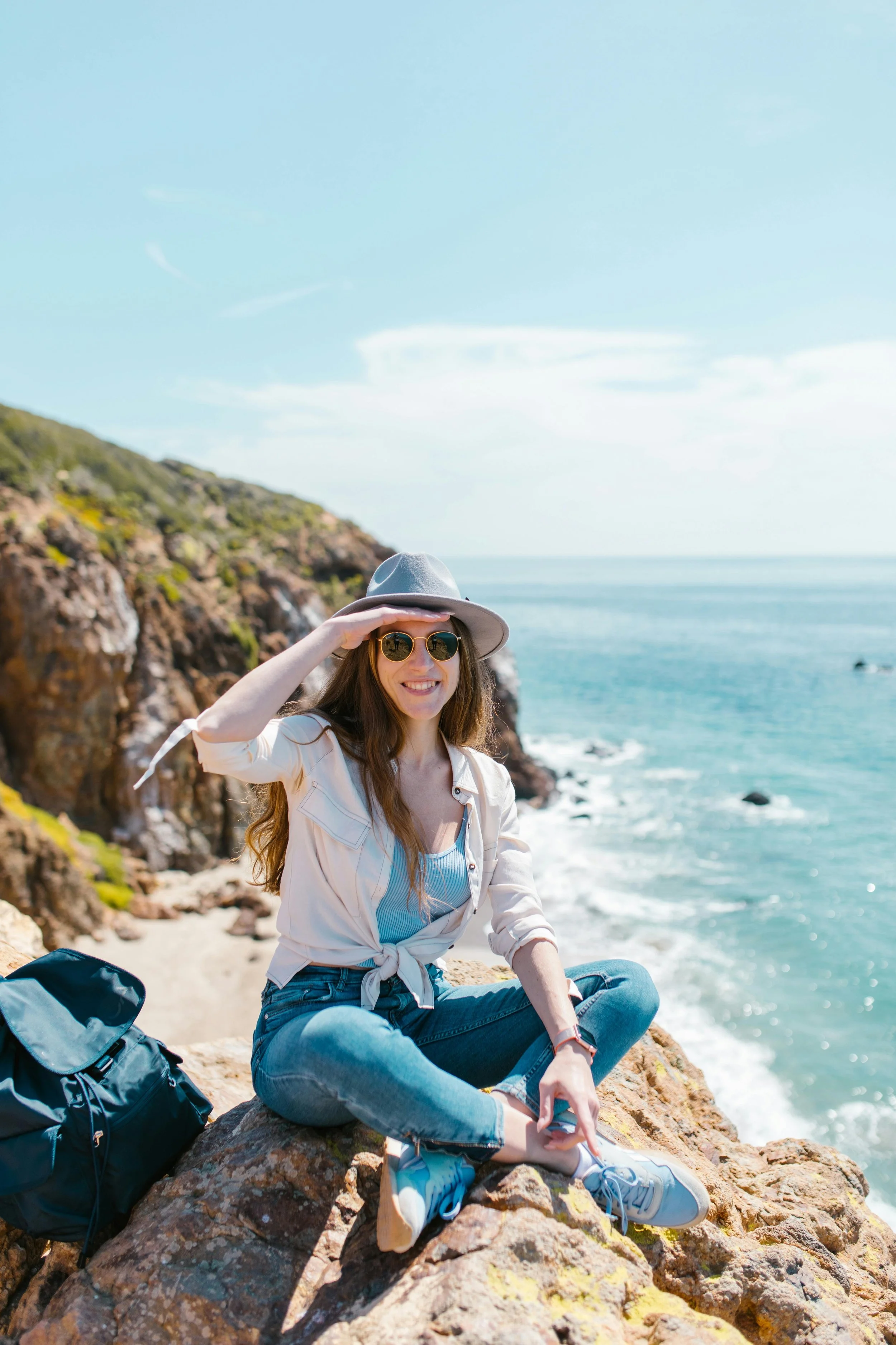 Woman smiling in front of the beach