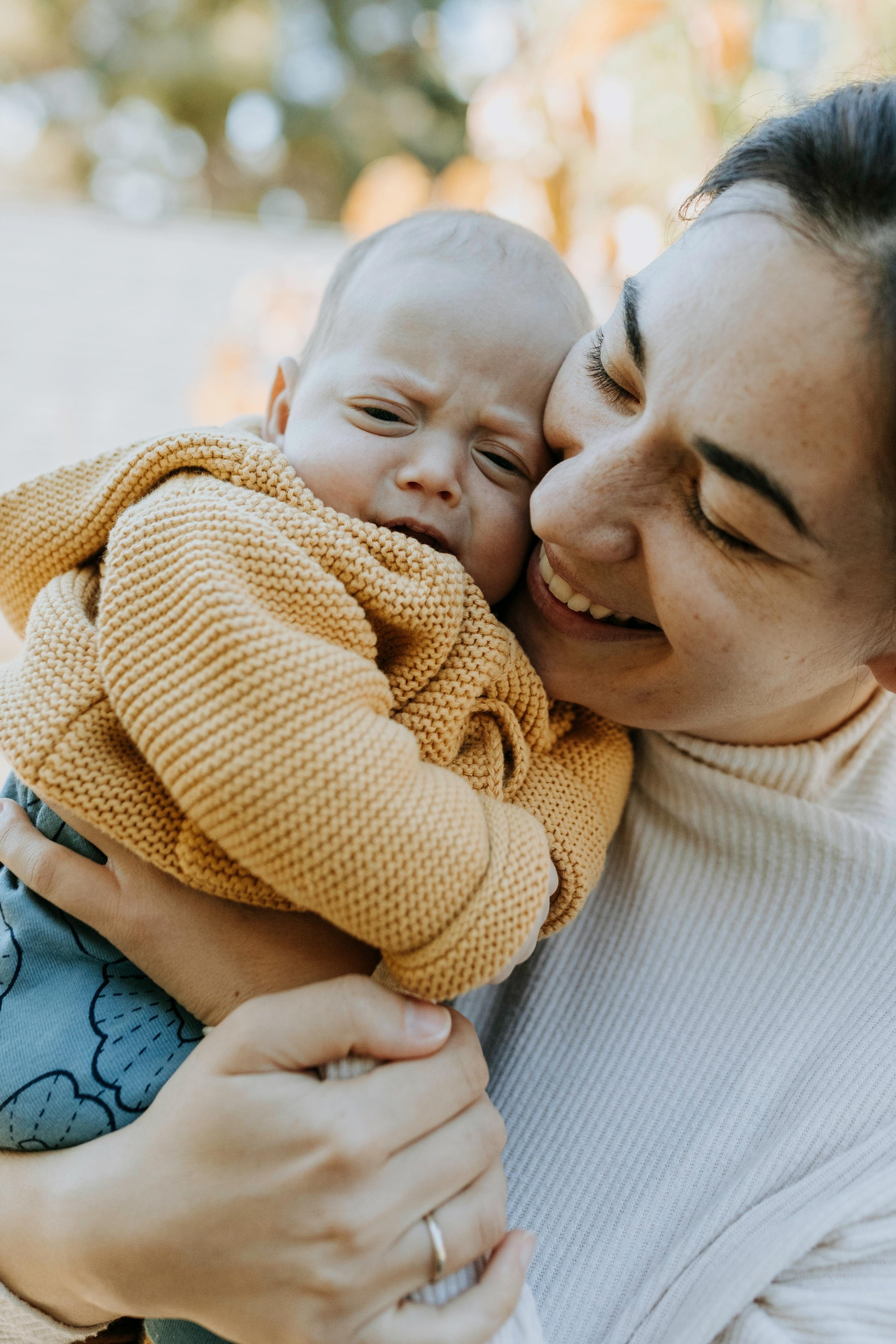 Mom smiling and holding her new baby