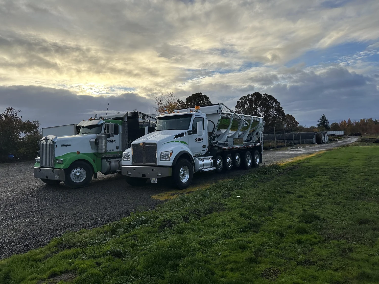 Andy’s trucks parked beside a field