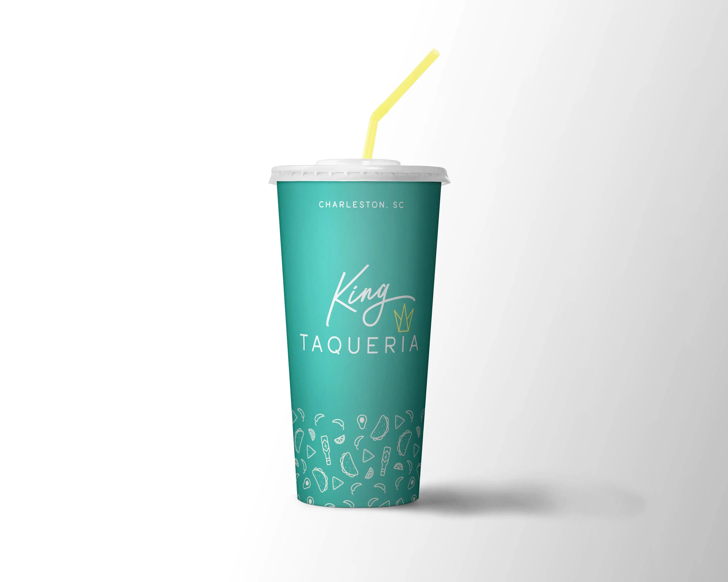 A teal disposable cup with a white lid and yellow straw, labeled 'King Taqueria' and featuring small taco and chili pepper illustrations, with 'Charleston, SC' written at the top.
