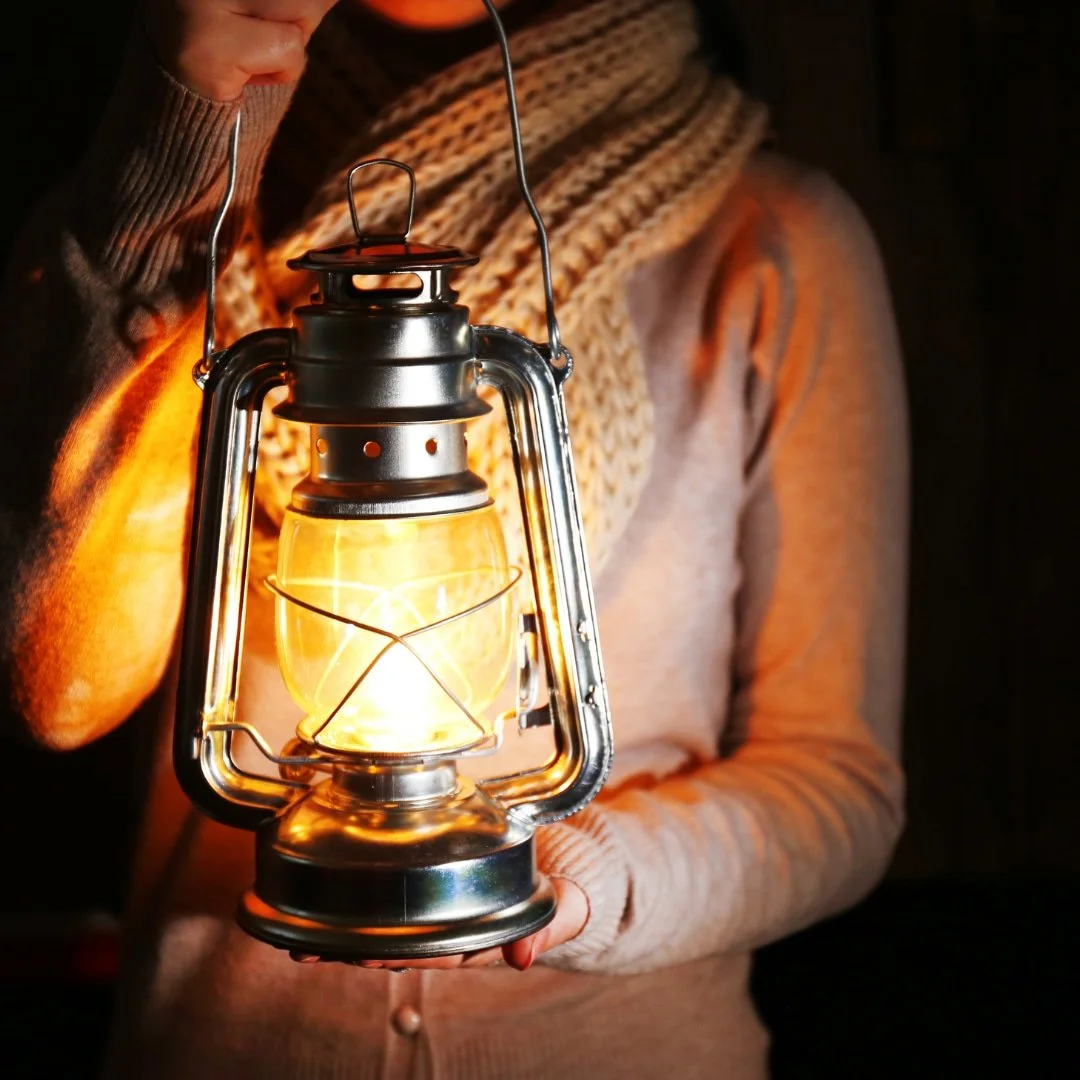 woman with lantern in her hands signifying the light that leads the way to healing