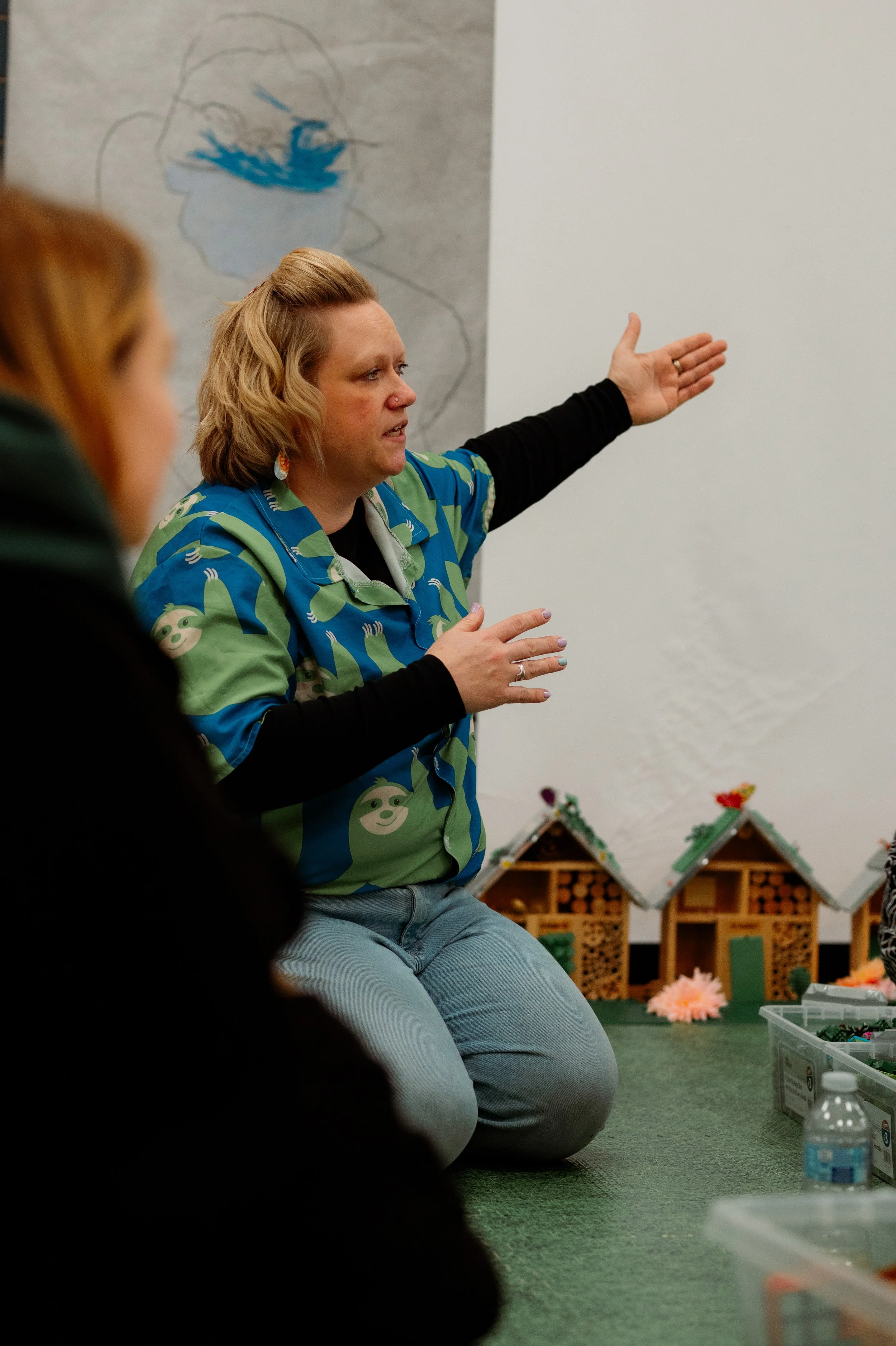 Helen talks to adults at the sustainability play experience about communicating climate matters in a way that engages and isn't doom fille-