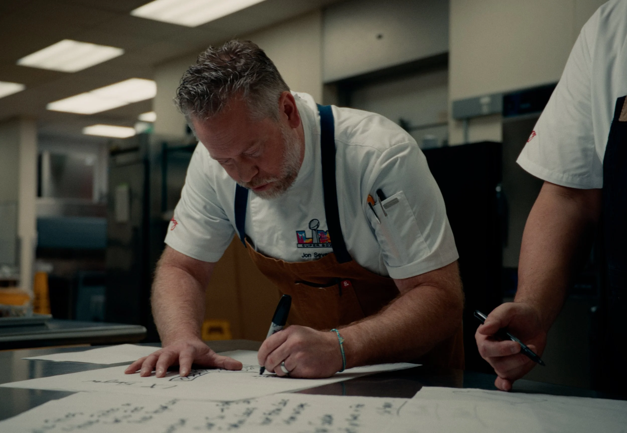 chef of levy foods creating the dishes for super bowl LX in the kitchen.
