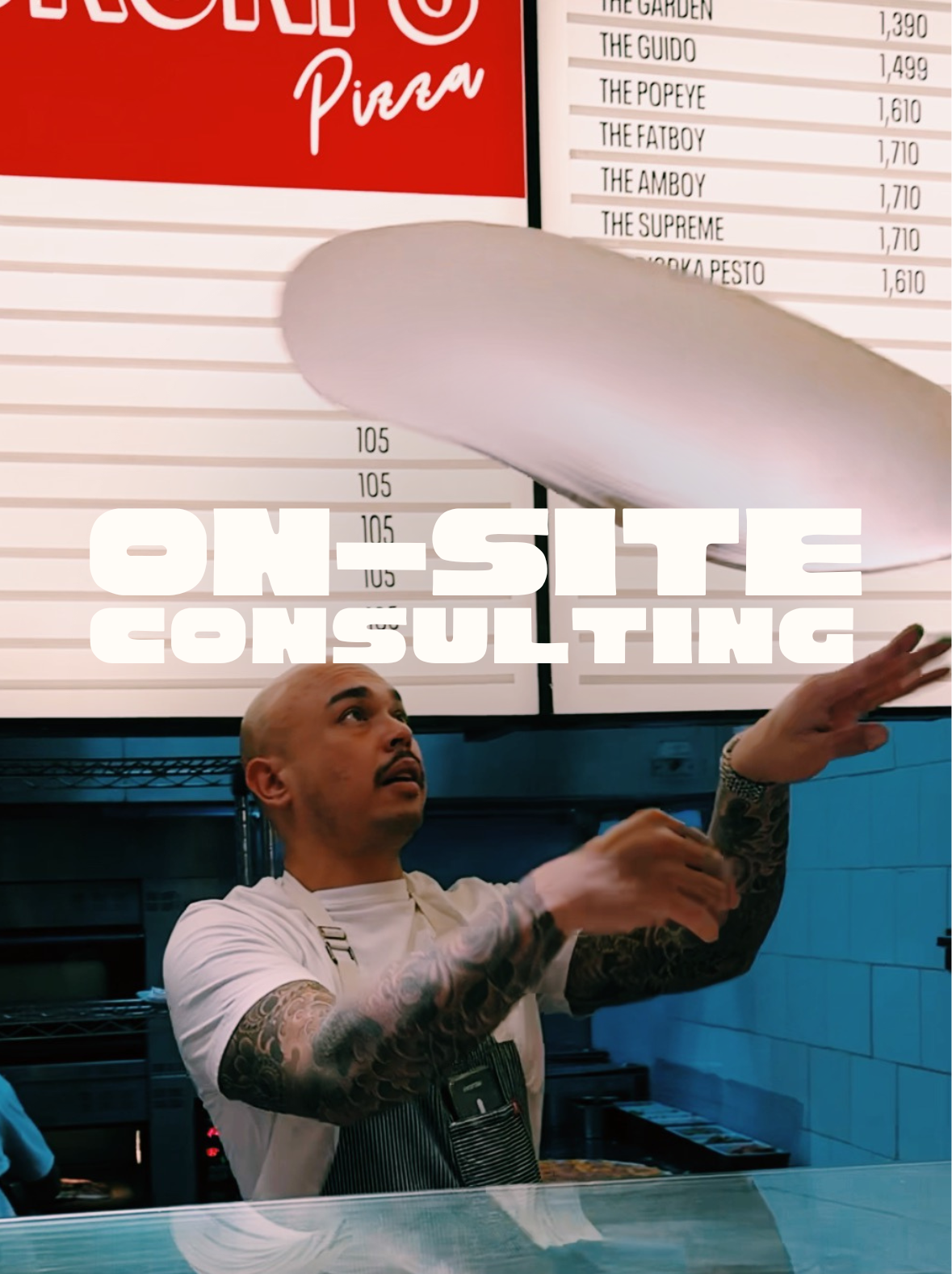 Pizza consultant Alastair Hannmann Al the Pizza Buddha is tossing New York style pizza dough in a pizzeria. Overlaid text reads 'ON SITE CONSULTING'. In the background, there is a menu with various pizza names and prices.
