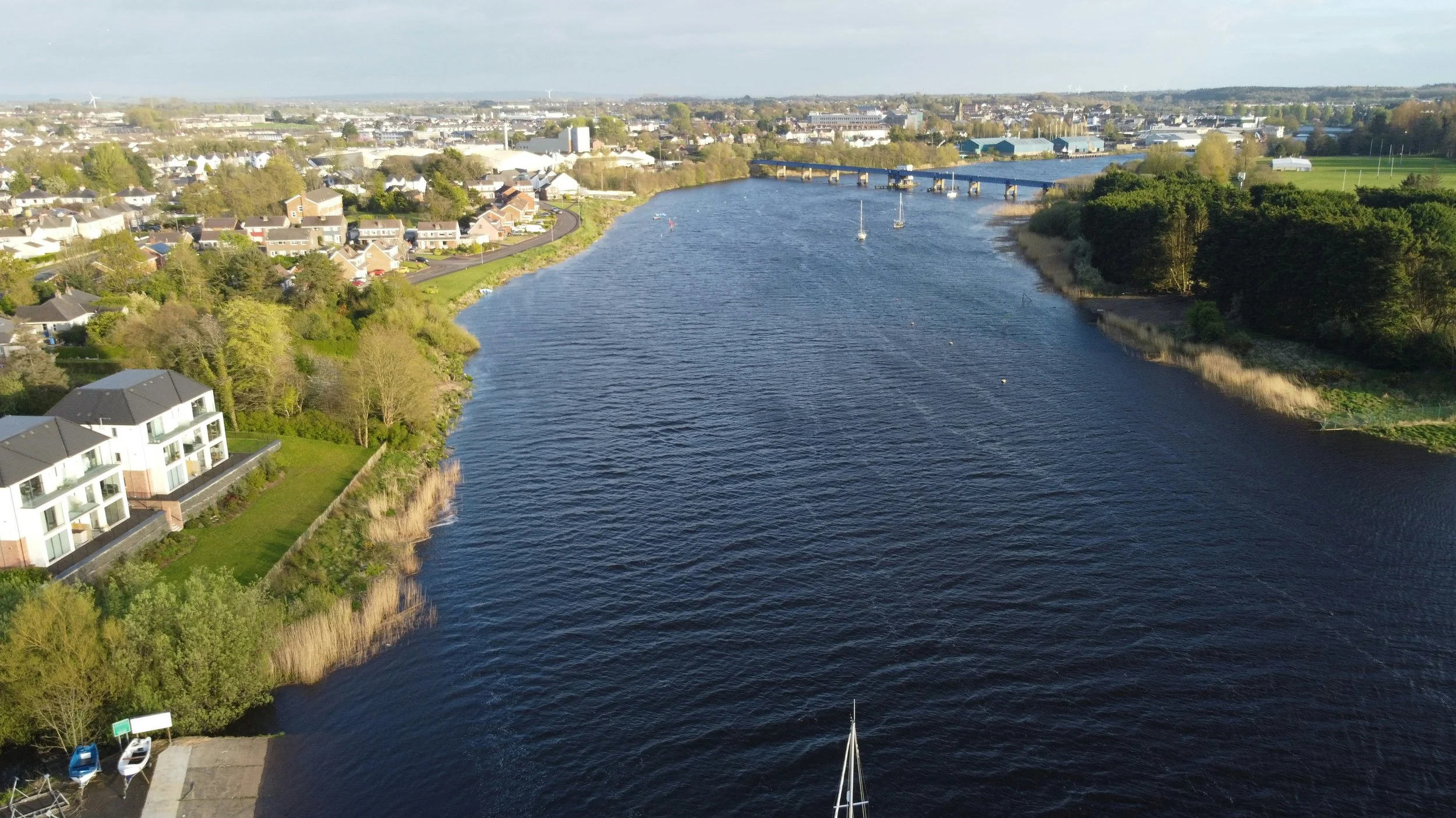 Aerial view of a river winding past a town in the Northern Ireland countryside