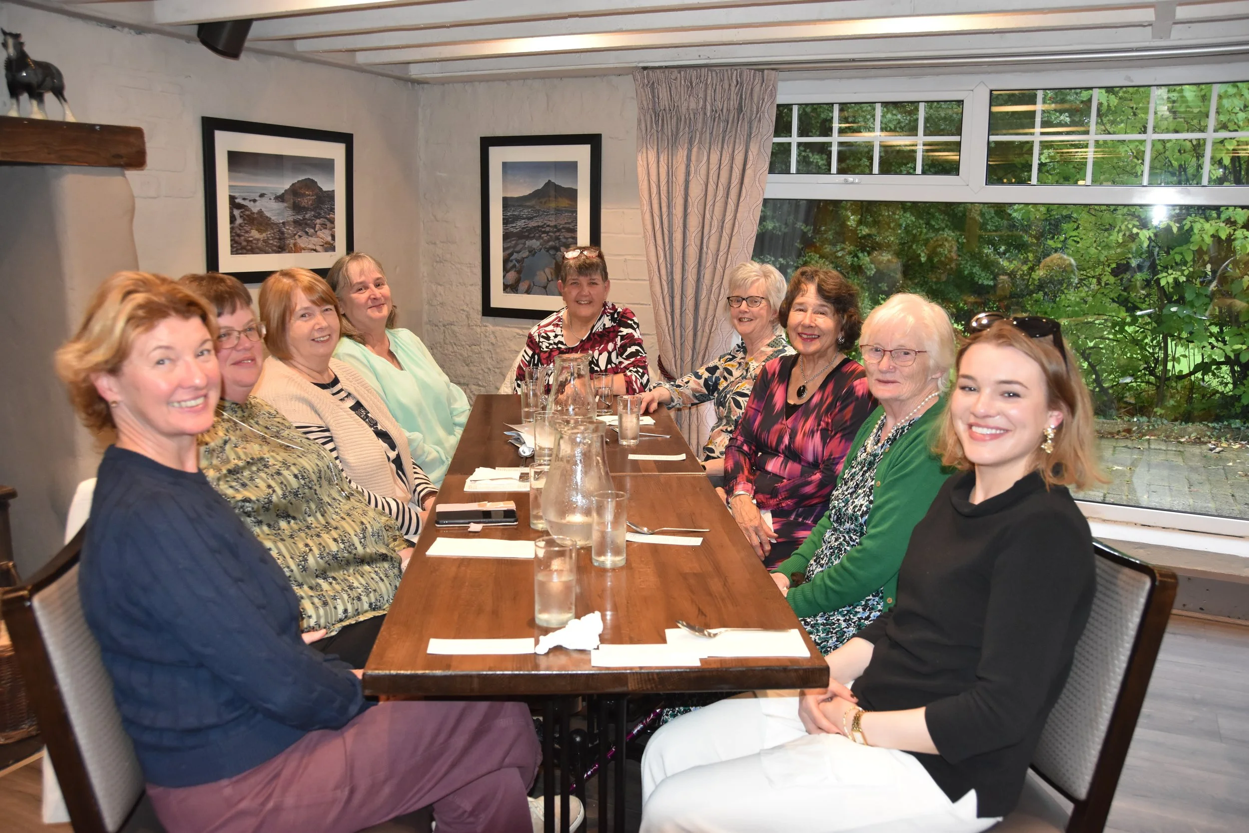 Congregation members enjoying a fellowship meal at a long table